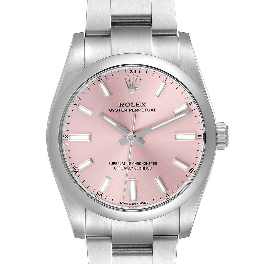 The Rolex Oyster Perpetual watch is shown from a top-down angle, highlighting the pink dial and stainless steel bracelet.