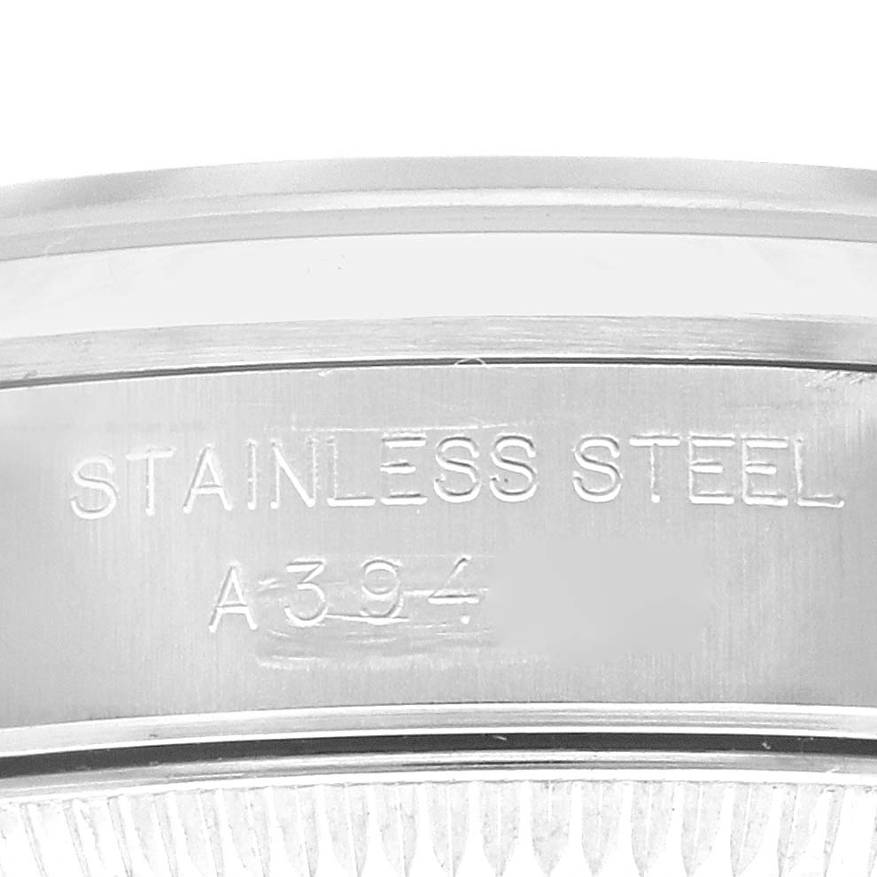 The image shows a close-up of the back casing of a Rolex Oyster Perpetual 76080 Women's Stainless Steel Pink Dial 76080 Women's Stainless Steel Pink Dial watch, including the "STAINLESS STEEL" engraving.