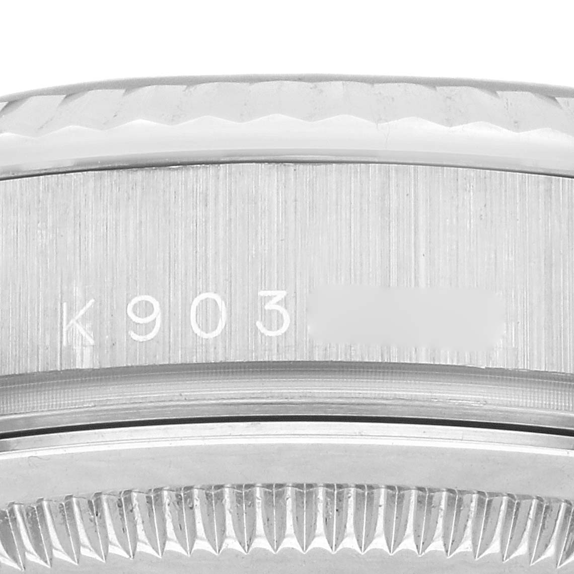 This close-up image shows the engraved serial number and the grooved bezel of the Rolex President 118239 Men's White Gold Silver Dial 118239 Men's White Gold Silver Dial model.