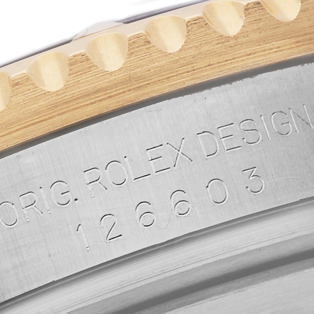 This image shows a close-up of the side engraving and part of the bezel of a Rolex Sea-Dweller 126603 Men
s Steel and Gold (two tone) Black Dial 126603 Men
s Steel and Gold (two tone) Black Dial watch.