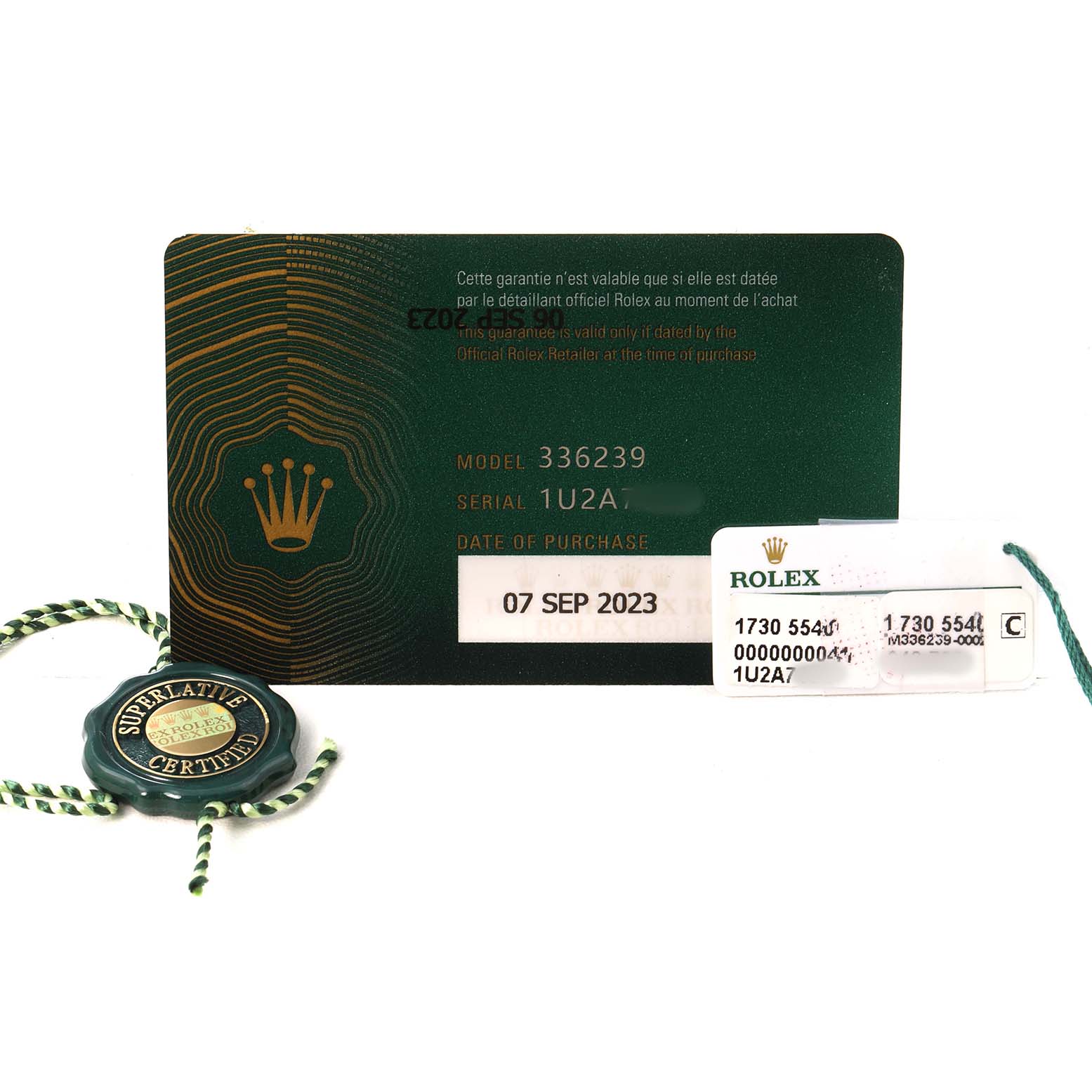 The image shows a warranty card and tag for a Rolex Sky-Dweller 336239 Men's White Gold Black Dial.