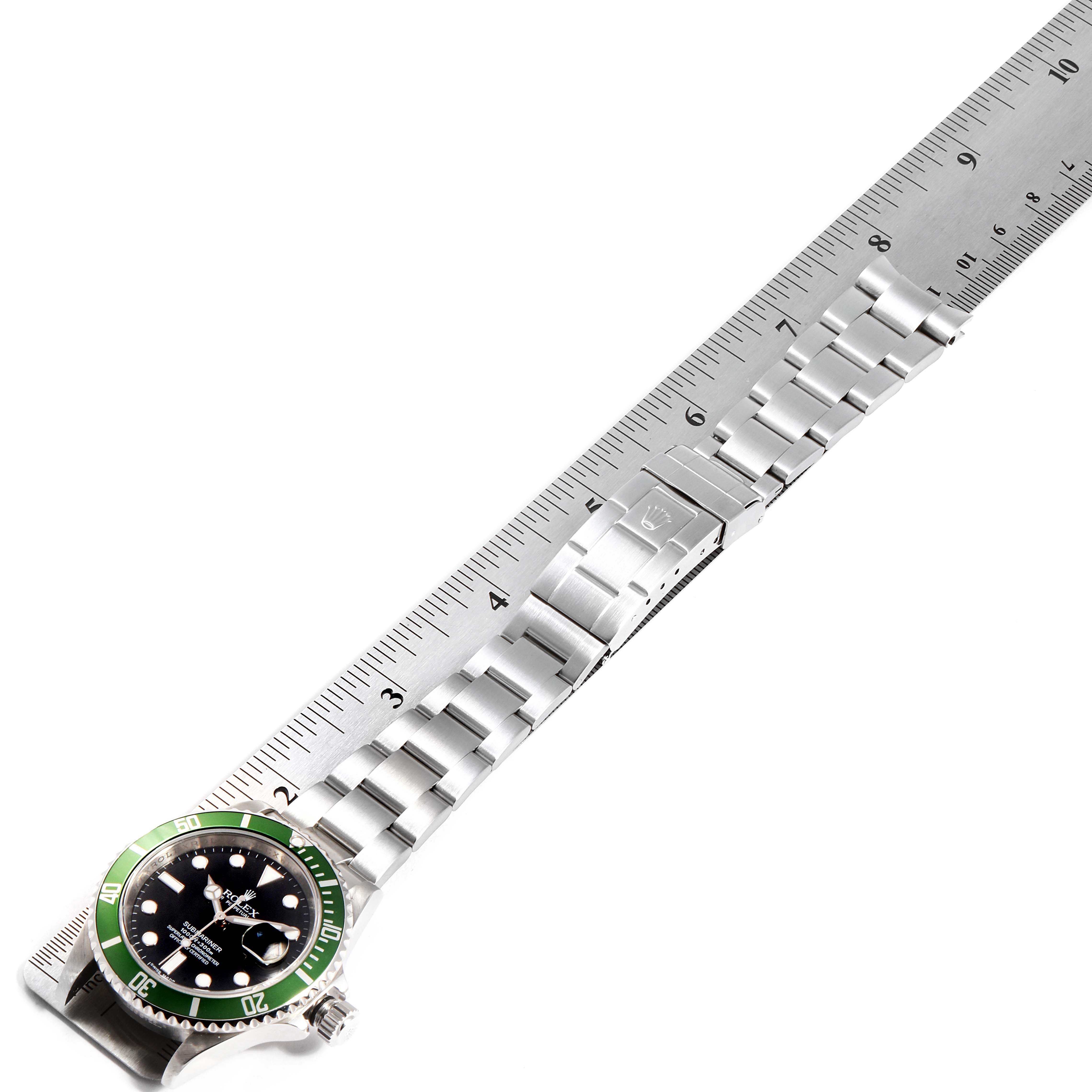 The Rolex Submariner 16610LV Men's Stainless Steel Black Dial 16610LV Men's Stainless Steel Black Dial watch is shown from an oblique top view, displaying the face, bezel, and full length of the bracelet against a ruler.