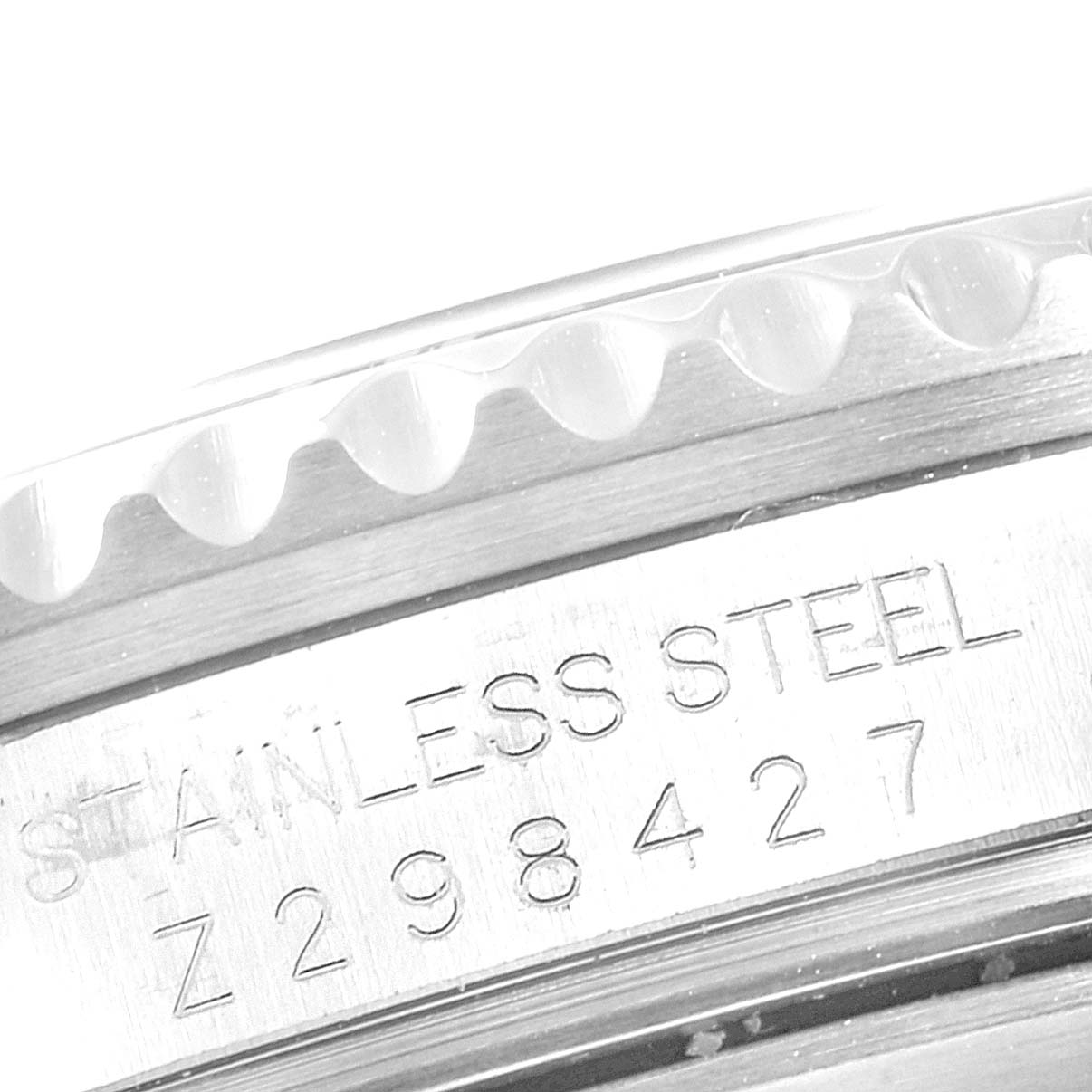 This image shows a close-up of the side of the Rolex Submariner 16610LV Men's Stainless Steel Black Dial 16610LV Men's Stainless Steel Black Dial watch case, highlighting the stainless steel material and serial number.