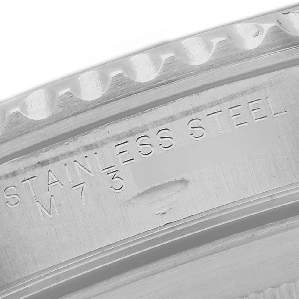 This is a close-up angle showing the engraved case back of a Rolex Submariner 14060M Men
s Stainless Steel Black Dial 14060M Men
s Stainless Steel Black Dial watch, highlighting the stainless steel inscription.