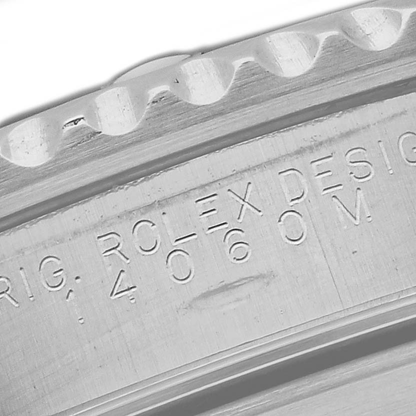 This close-up image shows the engraved bezel and part of the case of a Rolex Submariner 14060M Men
s Stainless Steel Black Dial 14060M Men
s Stainless Steel Black Dial watch.