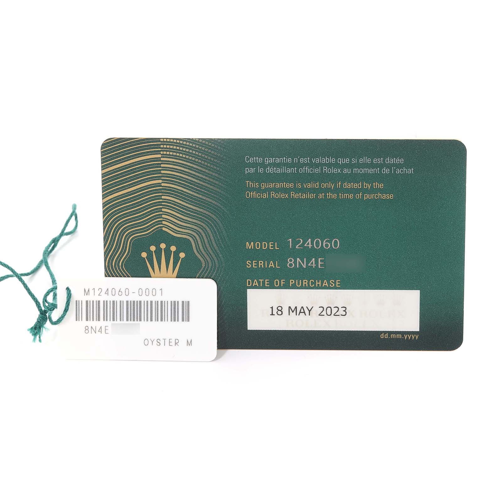 The image shows a warranty card and a tag for a Rolex Submariner M124060-0001 Men
s Stainless Steel Black Dial M124060-0001 Men
s Stainless Steel Black Dial model 124060, with a purchase date of 18 May 2023.