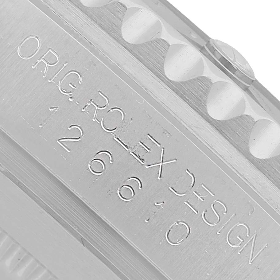 The image shows a close-up of the Rolex Submariner M126610LV-0002 Men's Stainless Steel Black Dial's case side, highlighting the engraving details.