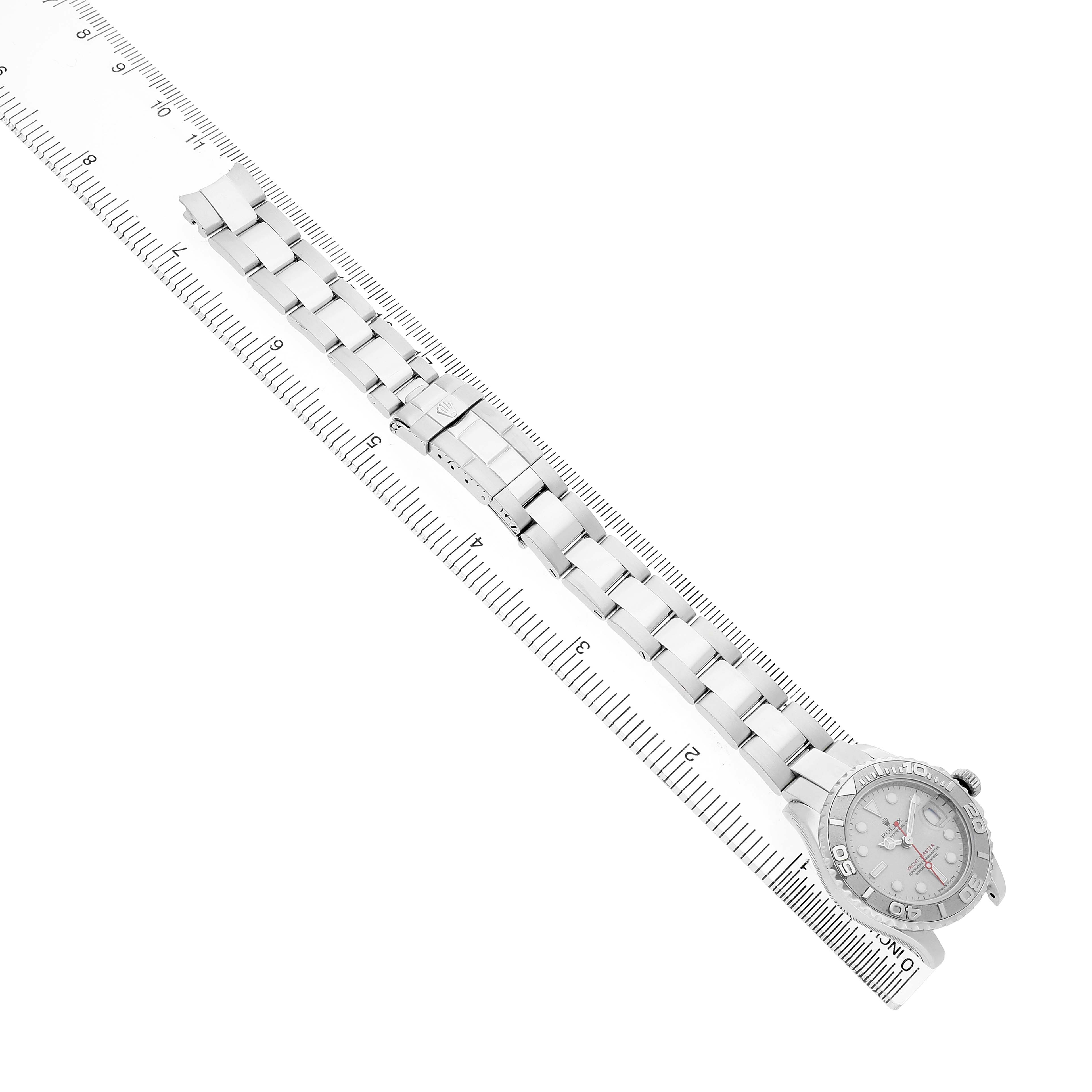 The Rolex Yacht-Master 169622 Women's Stainless Steel Silver Dial watch is shown from a top-down angle, highlighting the full bracelet and dial on a ruler.