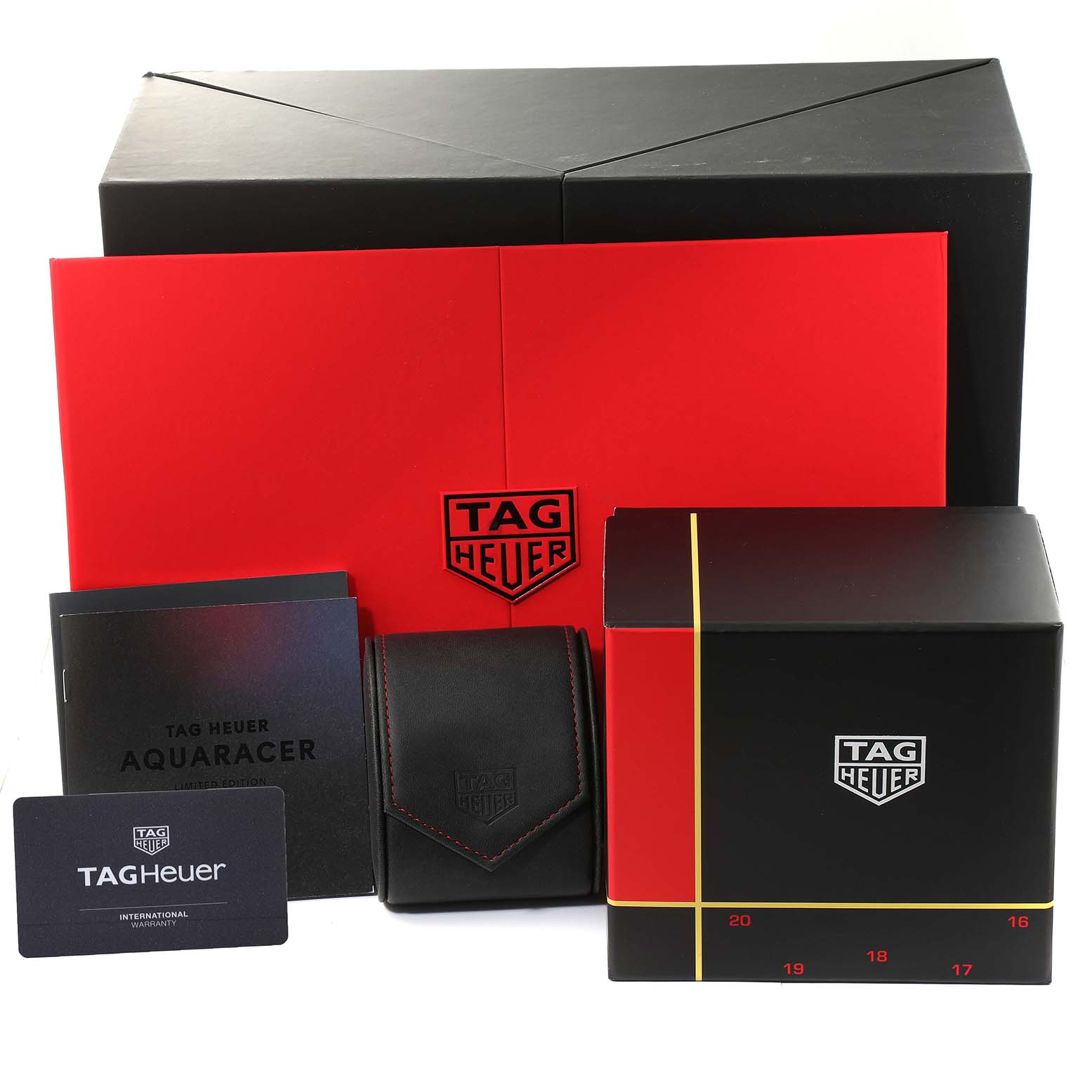 The image shows packaging and accessories of the Tag Heuer Aquaracer WBP208C.FT6201 Men's Titanium Black Dial WBP208C.FT6201 Men's Titanium Black Dial, including boxes, a pouch, manuals, and a warranty card.
