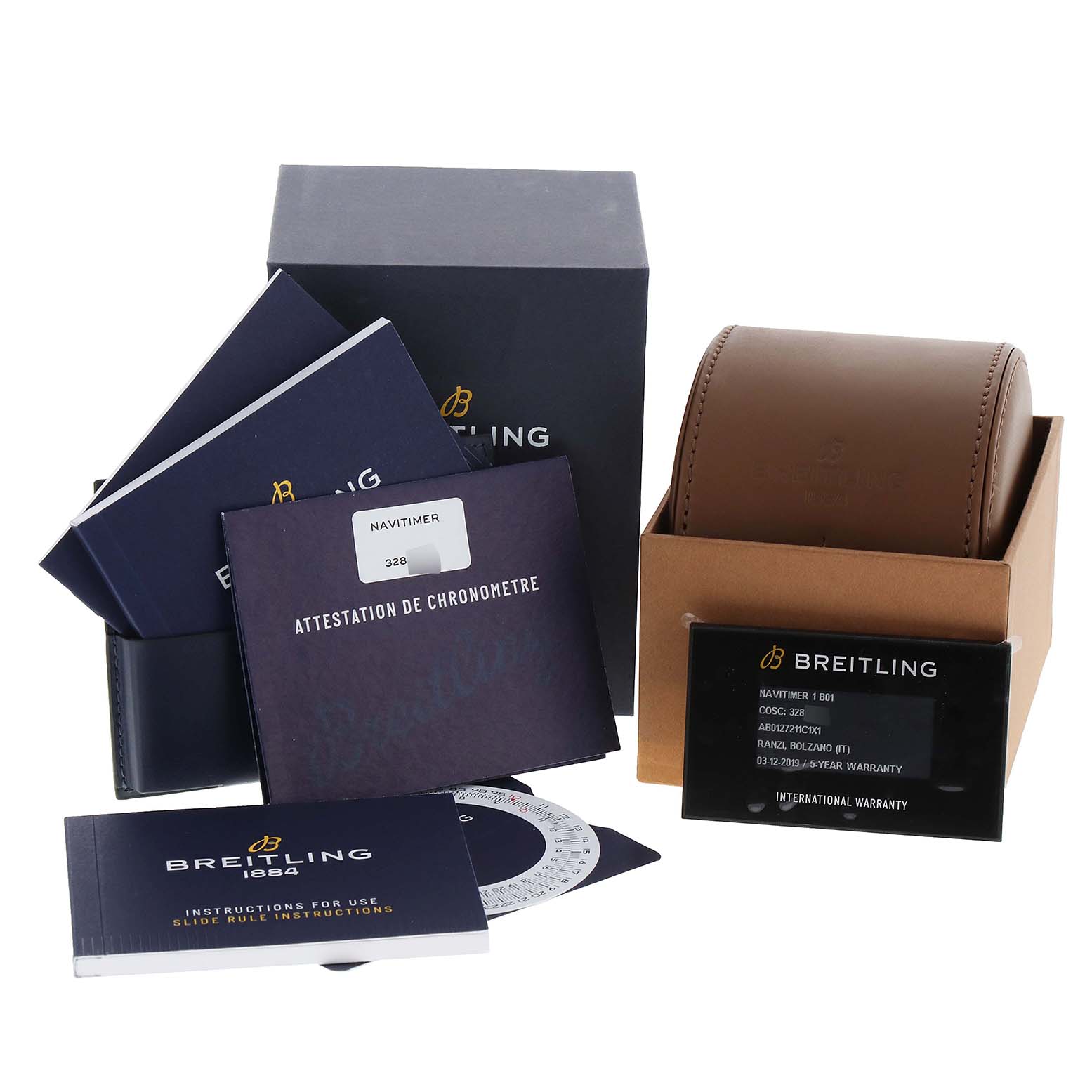 The image shows accessory parts for a Breitling Navitimer AB0127 Men
s Stainless Steel Blue Dial AB0127 Men
s Stainless Steel Blue Dial watch, including manuals, warranty card, a box, and a travel case.