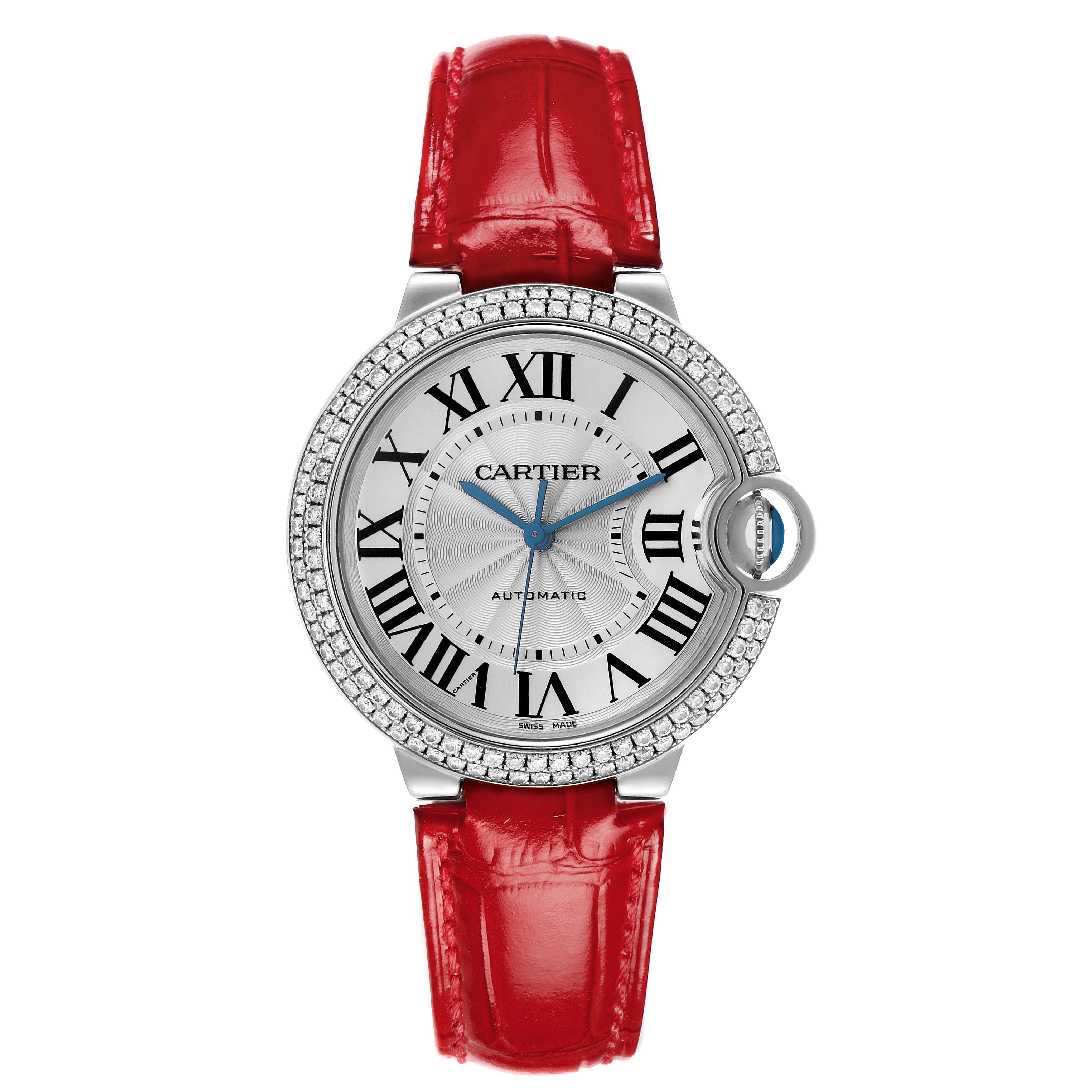 The Cartier Ballon Bleu WE900651 Women
s White Gold Silver Dial WE900651 Women
s White Gold Silver Dial watch is shown from a top-down angle, featuring its round face, Roman numerals, and red strap.