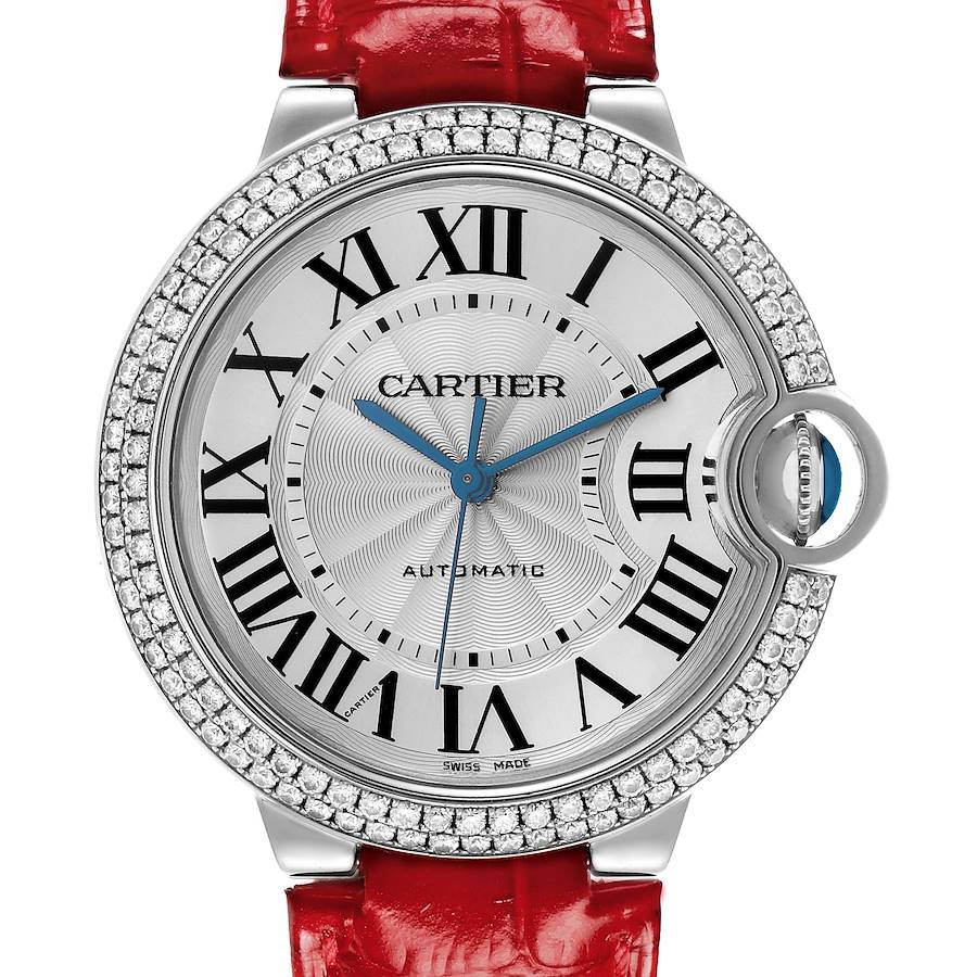 The Cartier Ballon Bleu watch is shown from the front, highlighting the face, bezel, and red strap.