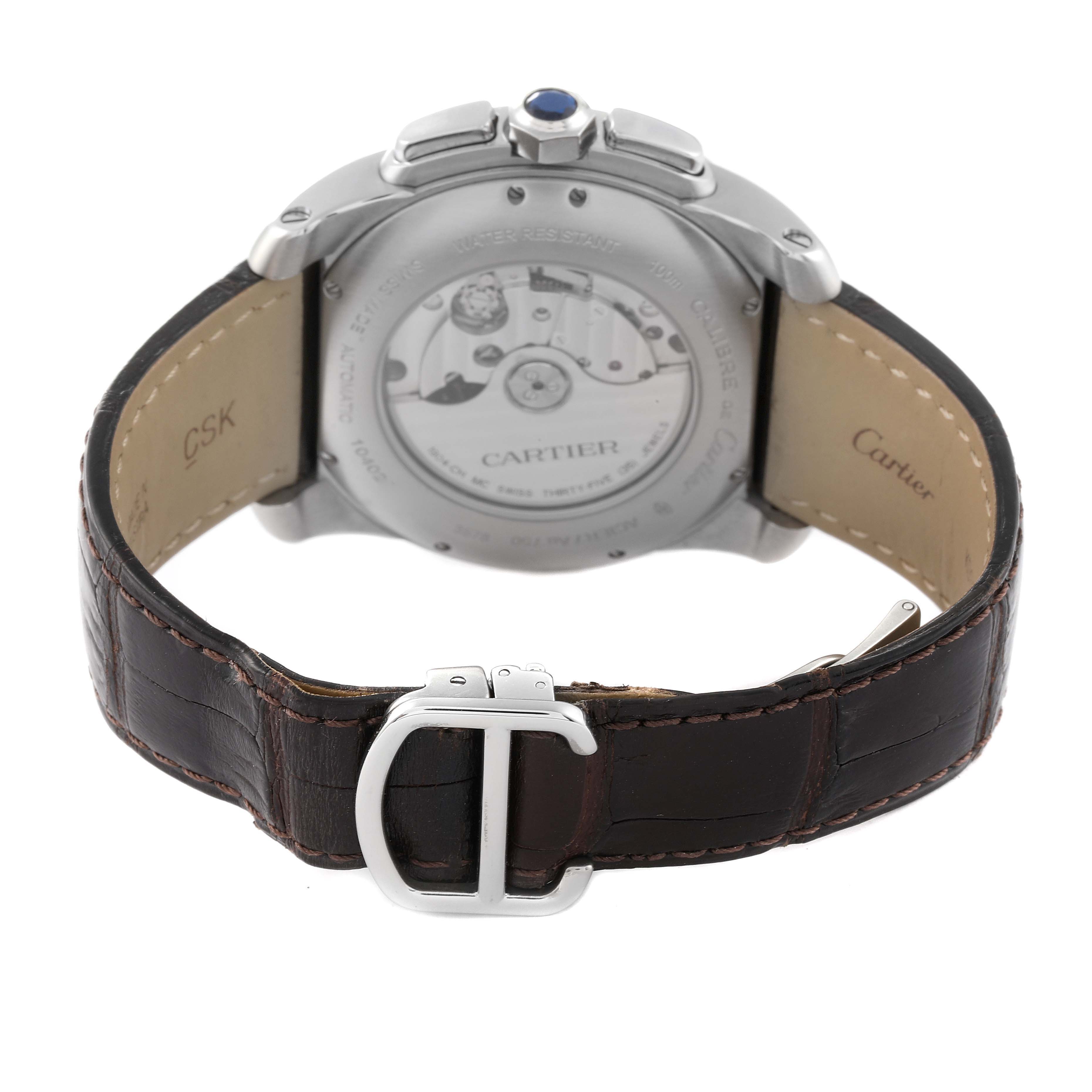 The image shows the back view of a Calibre de Cartier watch by Cartier, highlighting the leather strap and the watch's mechanical movement.