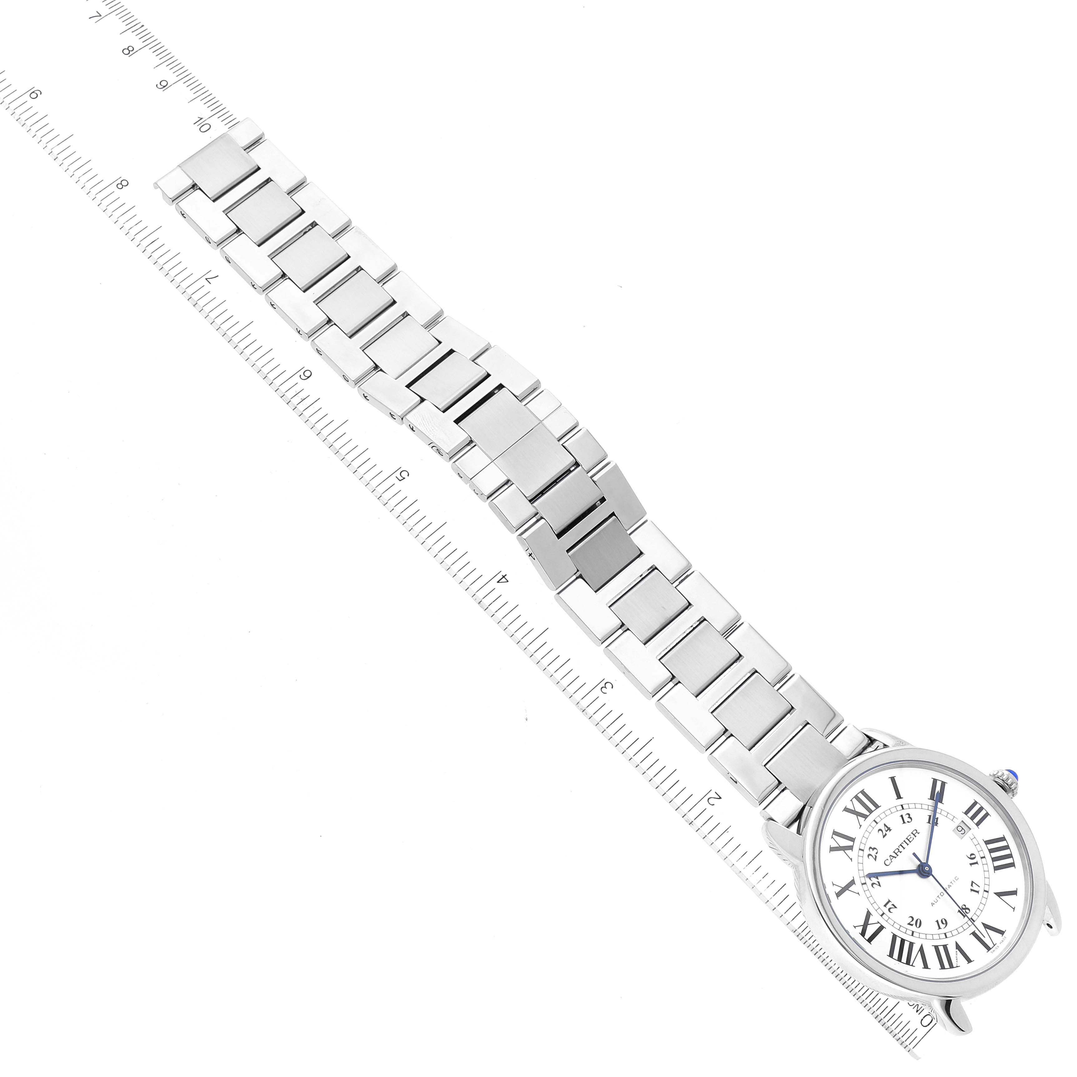The image shows a top-down view of a Cartier Ronde W6701011 Men
s Stainless Steel Silver Dial W6701011 Men
s Stainless Steel Silver Dial watch, displaying the face and band next to a ruler for scale.