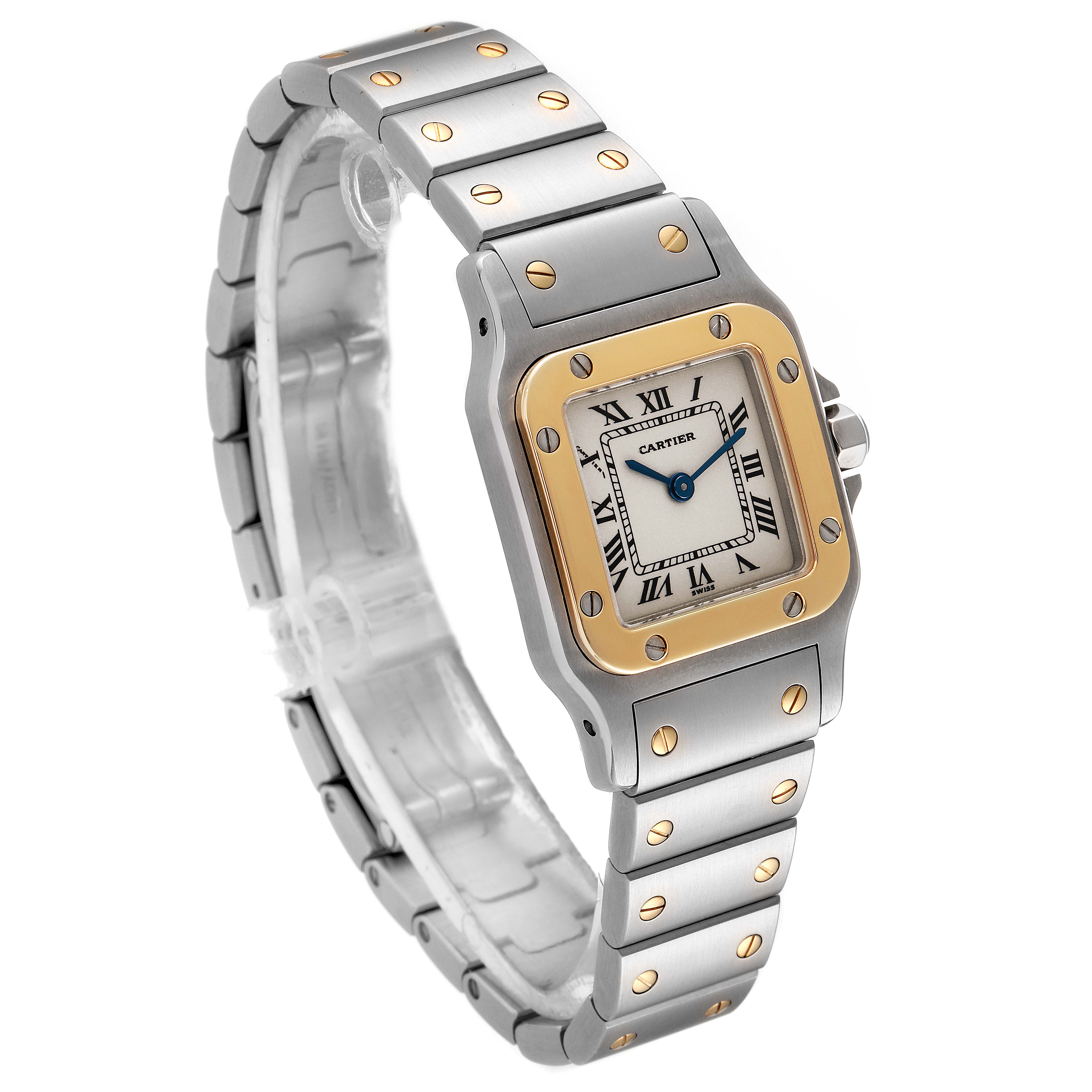 This image shows a Cartier Santos W20012C4 Women's Steel and Gold (two tone) Silver Dial W20012C4 Women's Steel and Gold (two tone) Silver Dial watch from a three-quarter angle, highlighting the face, bezel, and metal bracelet.