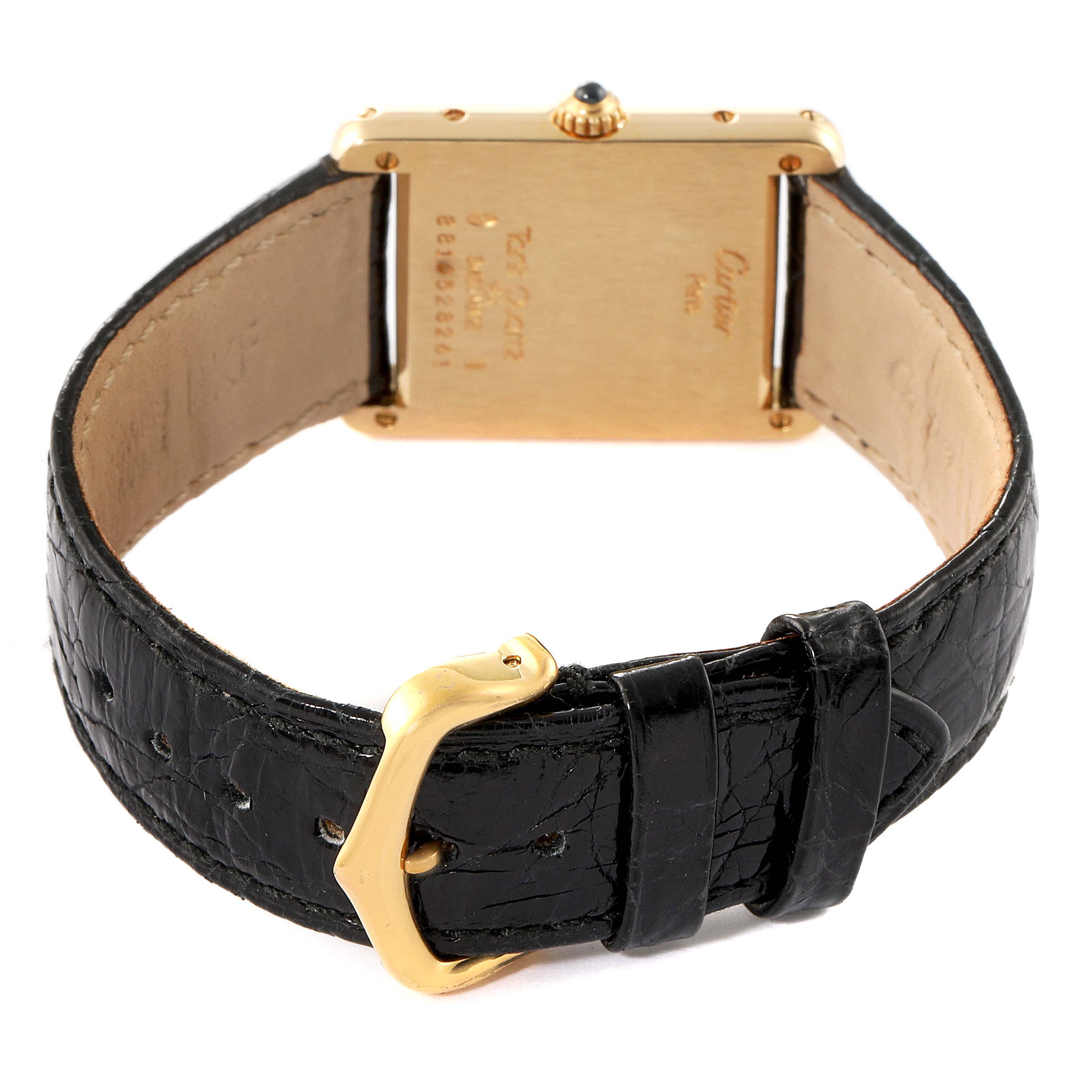 The image shows the back view of a Cartier Tank Classic Women's Yellow Gold White Dial Women's Yellow Gold White Dial watch with its black leather strap and gold buckle.