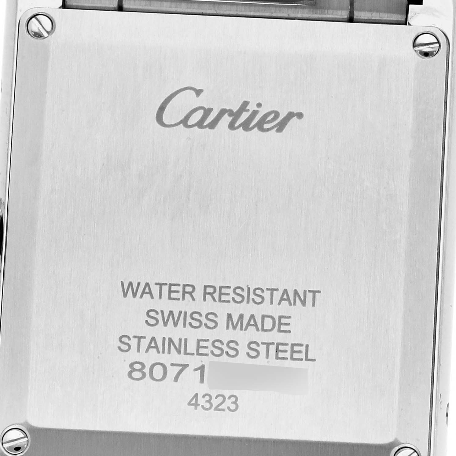 This image shows the back case of a Cartier Tank Must WSTA0052 Women's Stainless Steel Silver Dial WSTA0052 Women's Stainless Steel Silver Dial watch, highlighting engravings about water resistance, material, and serial numbers.