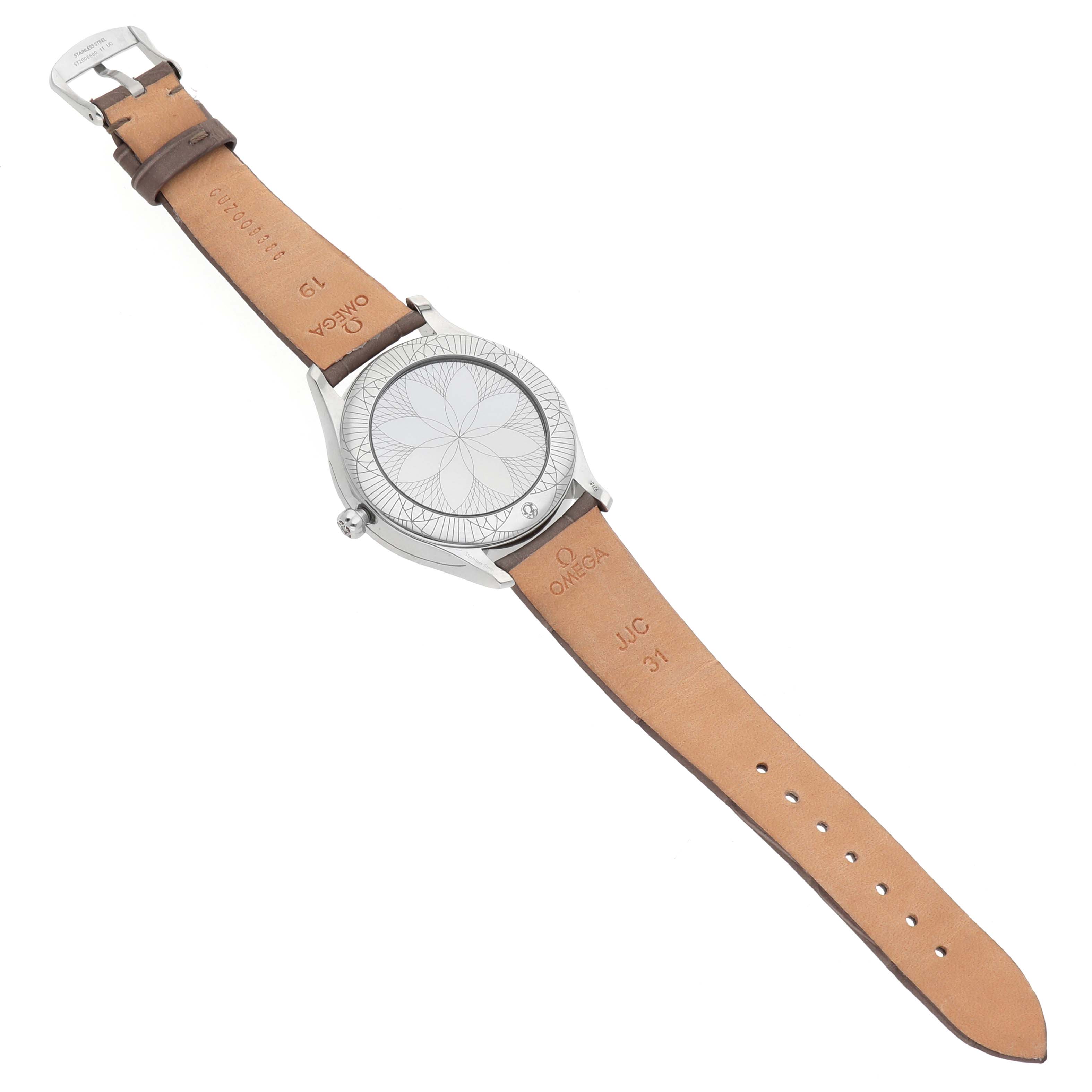 The image shows the back of an Omega 428.18.39.60.13.001 Women's Stainless Steel Beige Dial DeVille Tresor Steel Diamond Ladies Watch 428.18.39.60.13.001 with an engraved case back and leather strap.