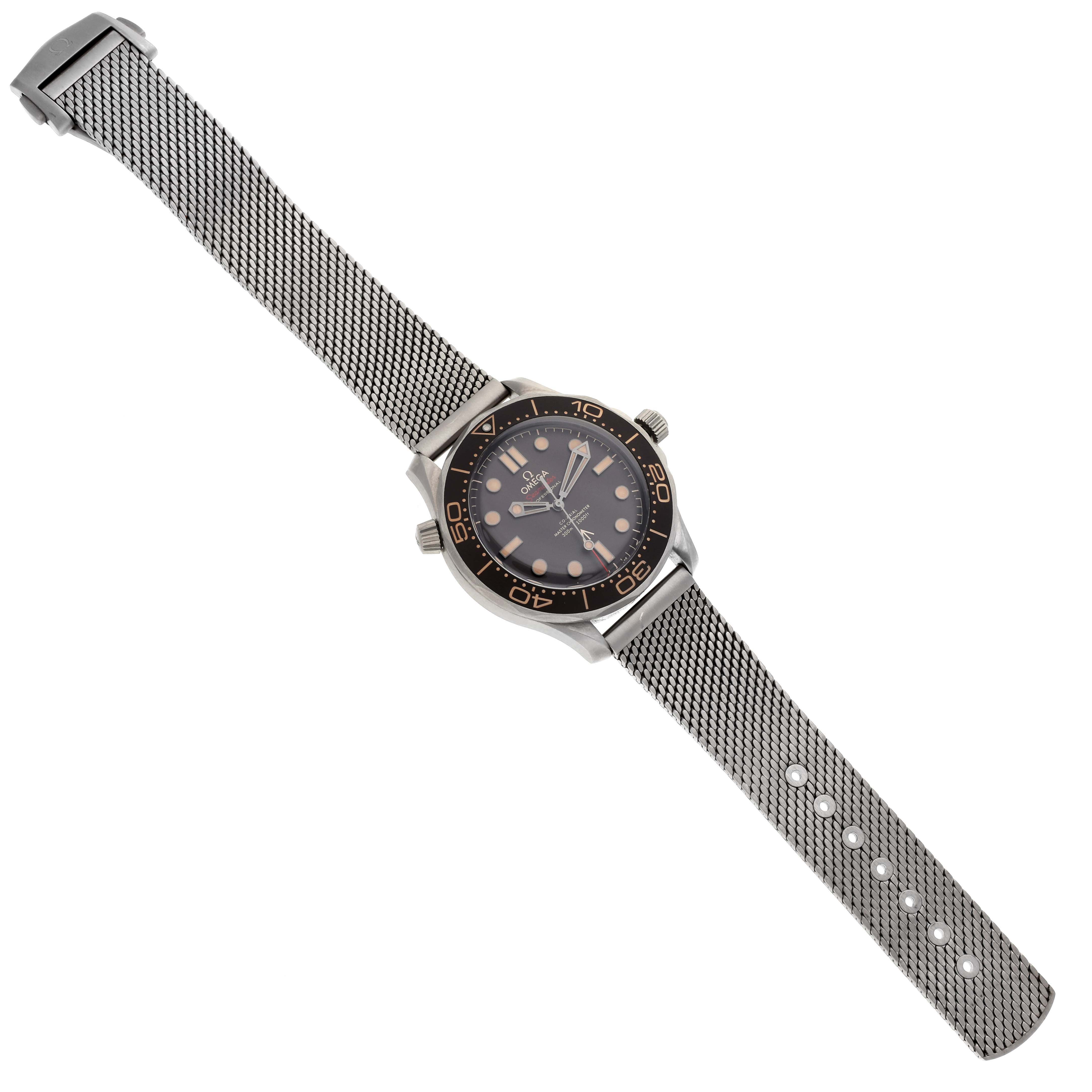 The Omega Seamaster 210.90.42.20.01.001 Men's Titanium Brown Dial 210.90.42.20.01.001 Men's Titanium Brown Dial watch is shown from a top-down angle, displaying its mesh bracelet, dial, and bezel.