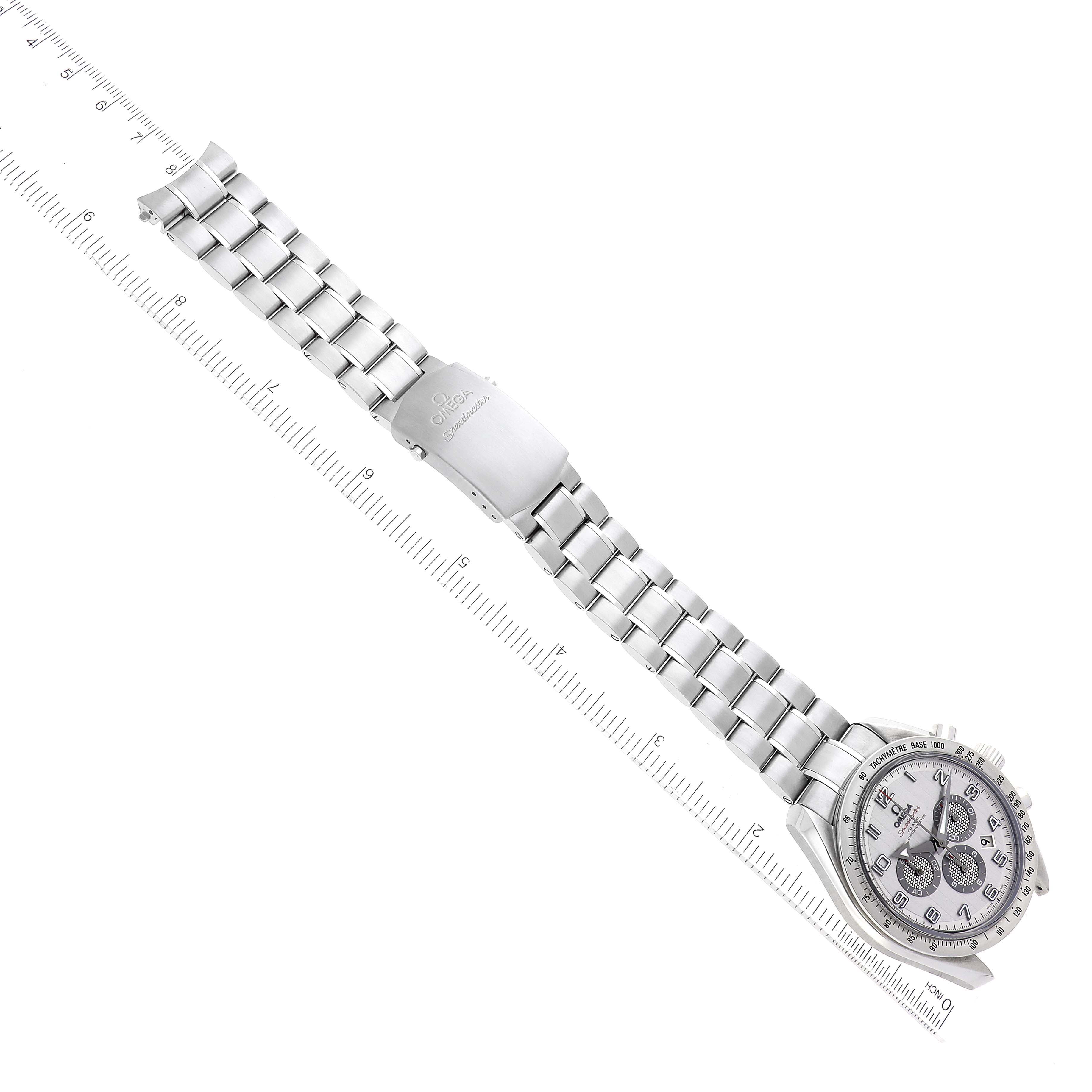 The image shows an Omega Speedmaster 321.10.44.50.02.001 Men
s Stainless Steel Silver Dial 321.10.44.50.02.001 Men
s Stainless Steel Silver Dial watch with a silver bracelet, lying flat with a ruler to measure its length.