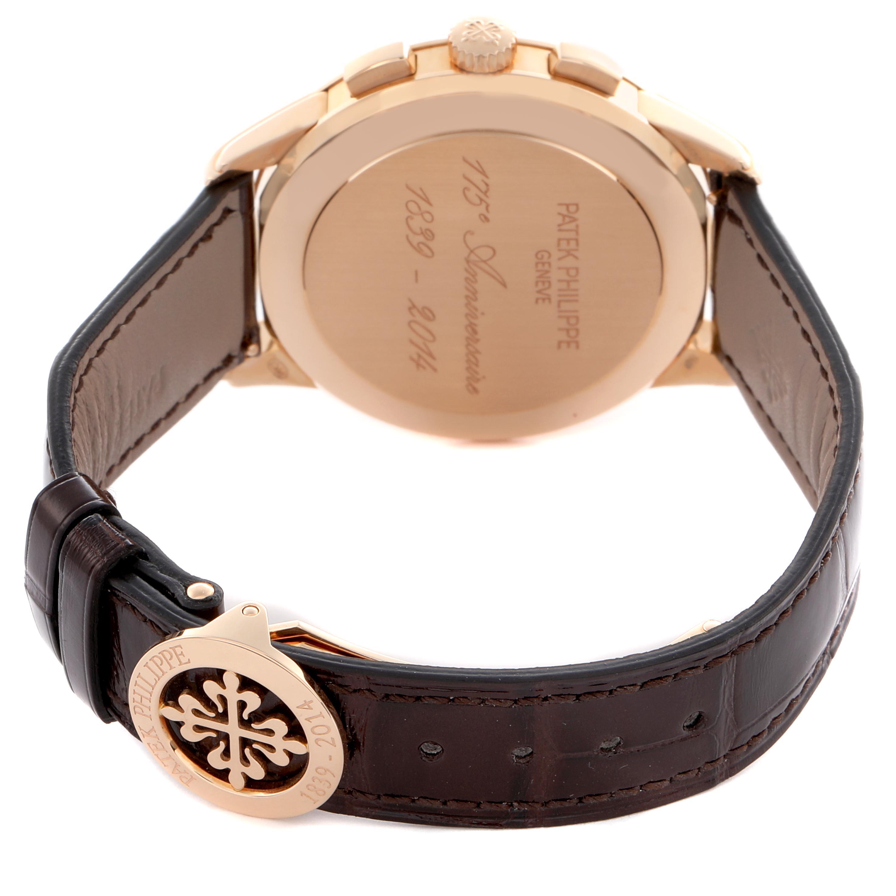 The image shows the back of a Patek Philippe Complications 5975R-001 Men
s Rose Gold Silver Dial 5975R-001 Men
s Rose Gold Silver Dial watch, highlighting the engravings and clasp on the leather strap.