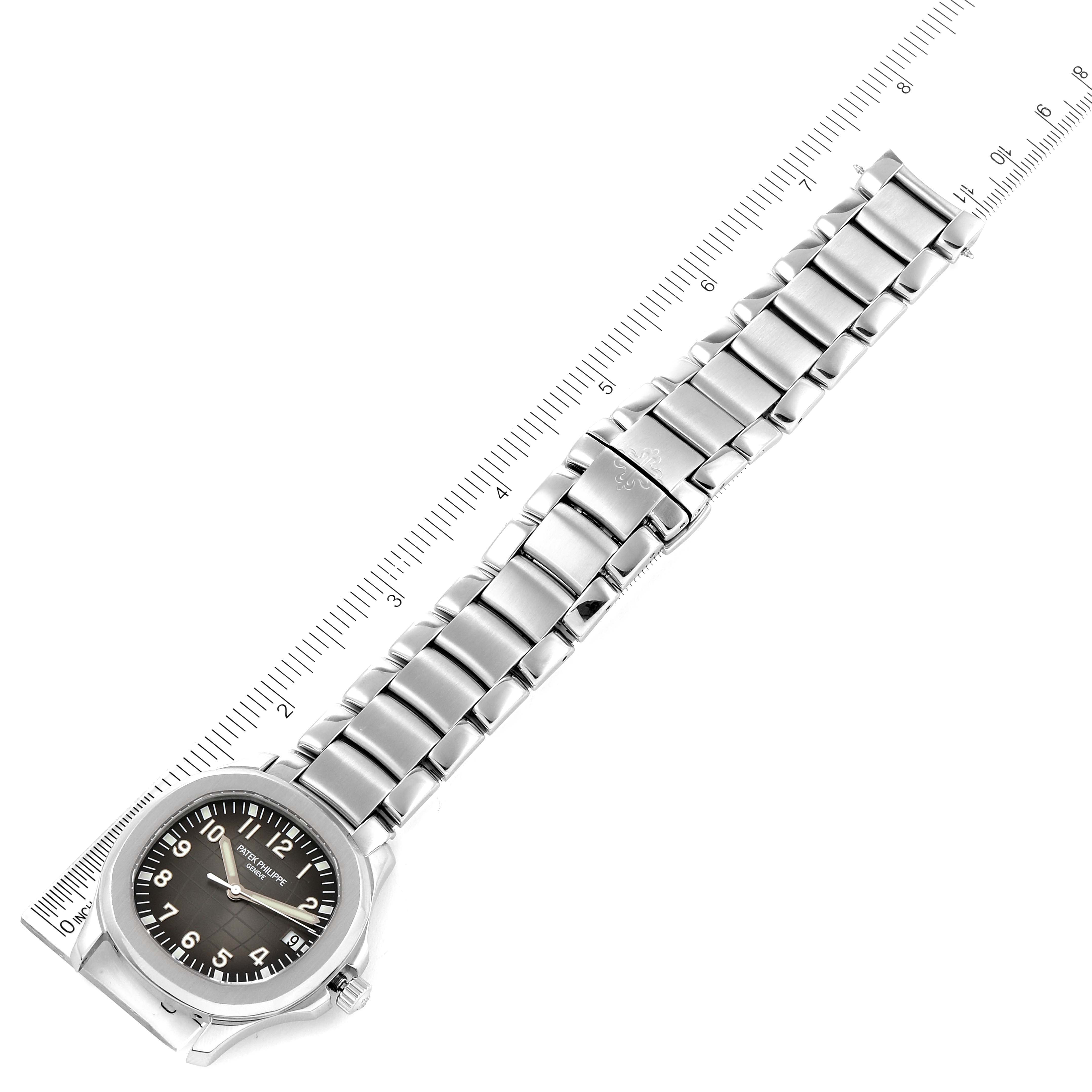 The image shows a silver bracelet for the Patek Philippe Aquanaut 5167/1A-001 Men's Stainless Steel Black Dial 5167/1A-001 Men's Stainless Steel Black Dial watch, aligned with a measuring ruler for scale.