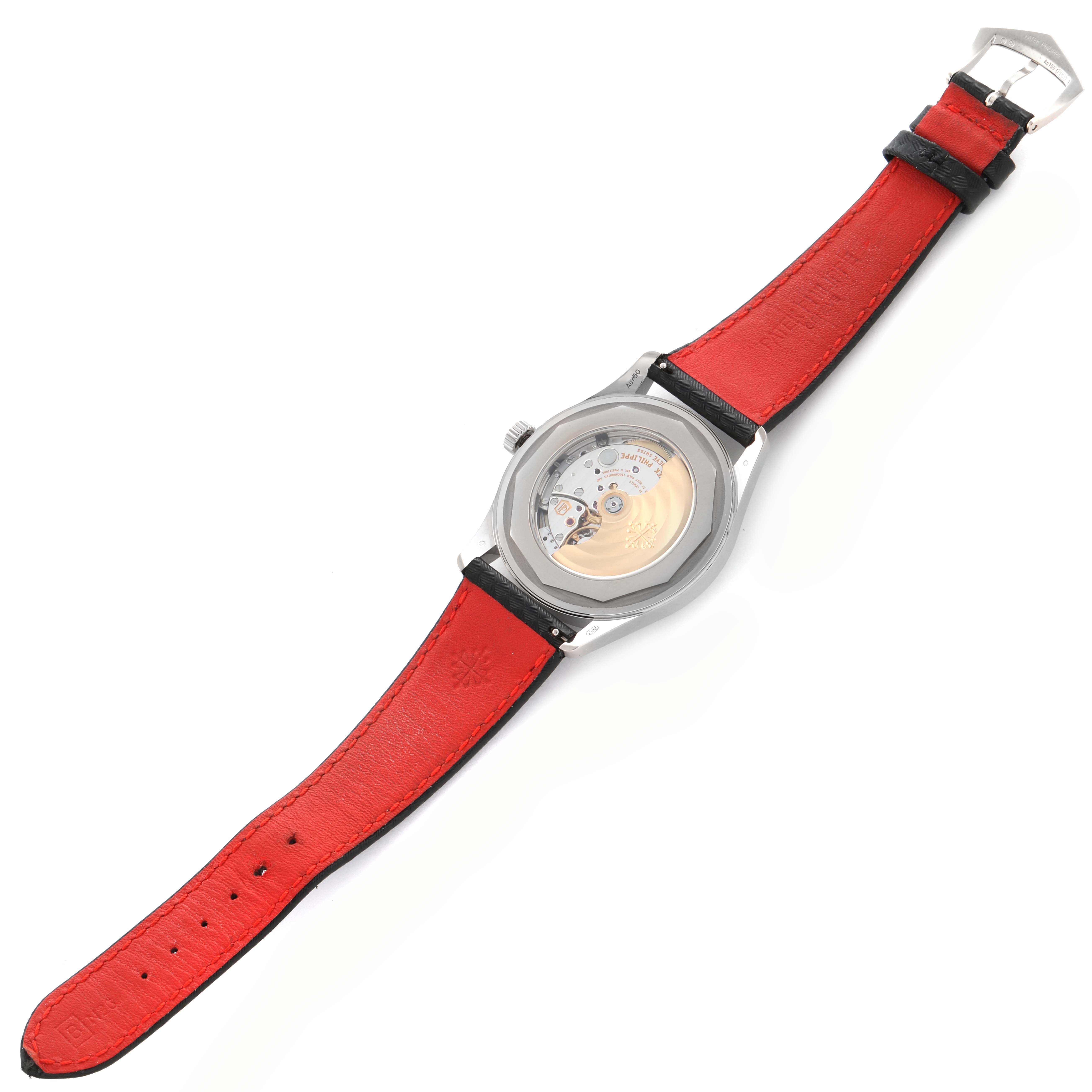 The Patek Philippe Calatrava 6007G Men
s White Gold Black Dial 6007G Men
s White Gold Black Dial watch is shown from the back, highlighting its movement and red leather strap.