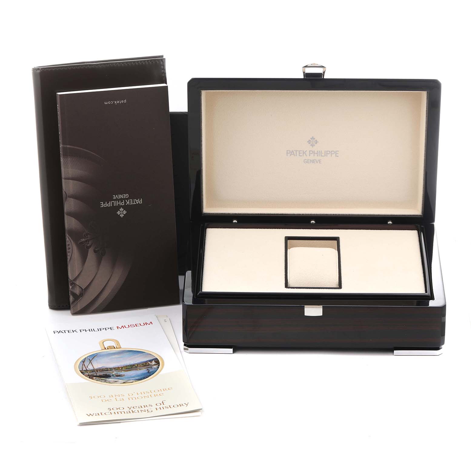 The image shows an open box for a Patek Philippe Calatrava 6007G Men
s White Gold Black Dial 6007G Men
s White Gold Black Dial watch, with manuals and a museum booklet beside it.