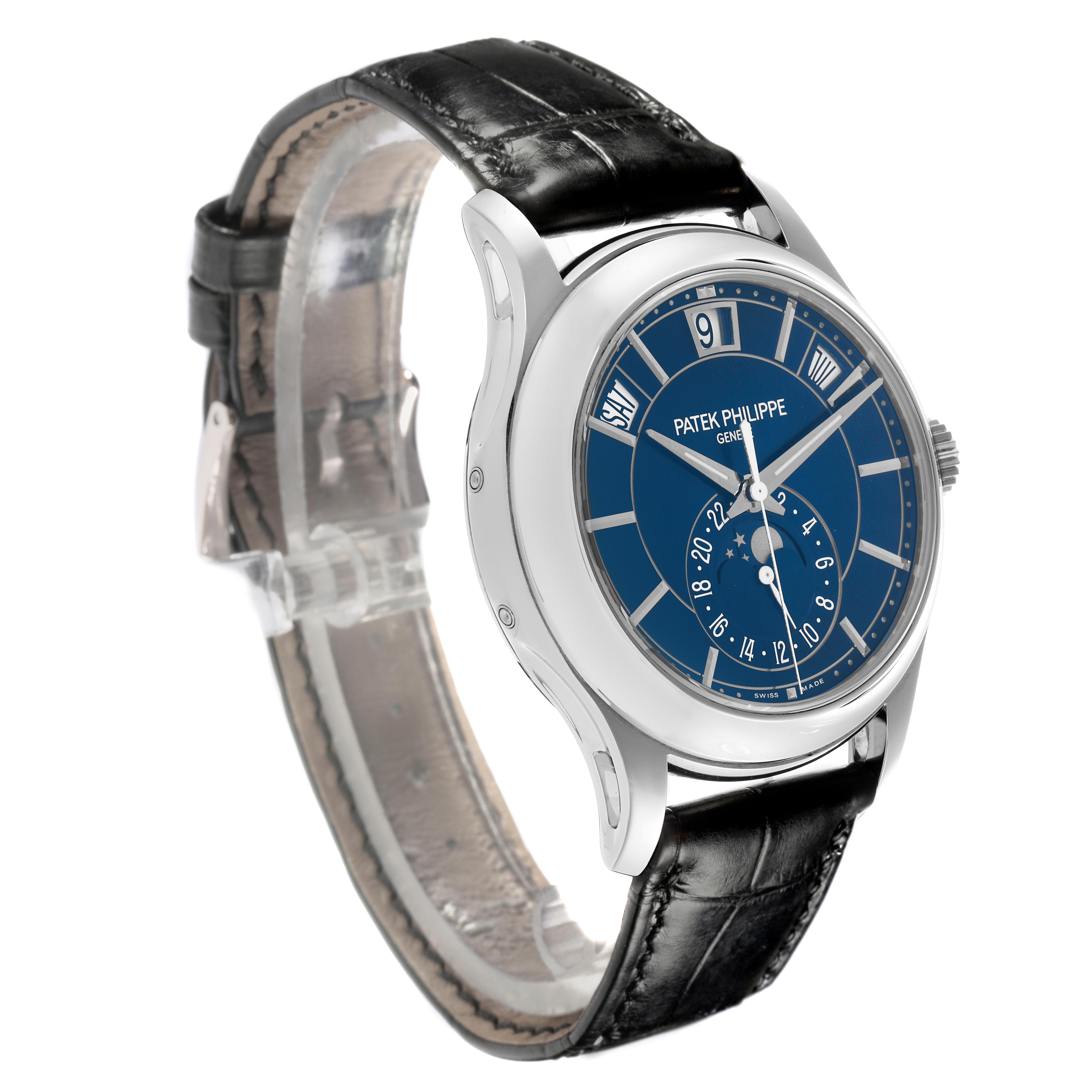 The Patek Philippe Complications 5205G-013 Men
s White Gold Blue Dial 5205G-013 Men
s White Gold Blue Dial watch is shown at a three-quarter angle, displaying its dial, case, and black leather strap.