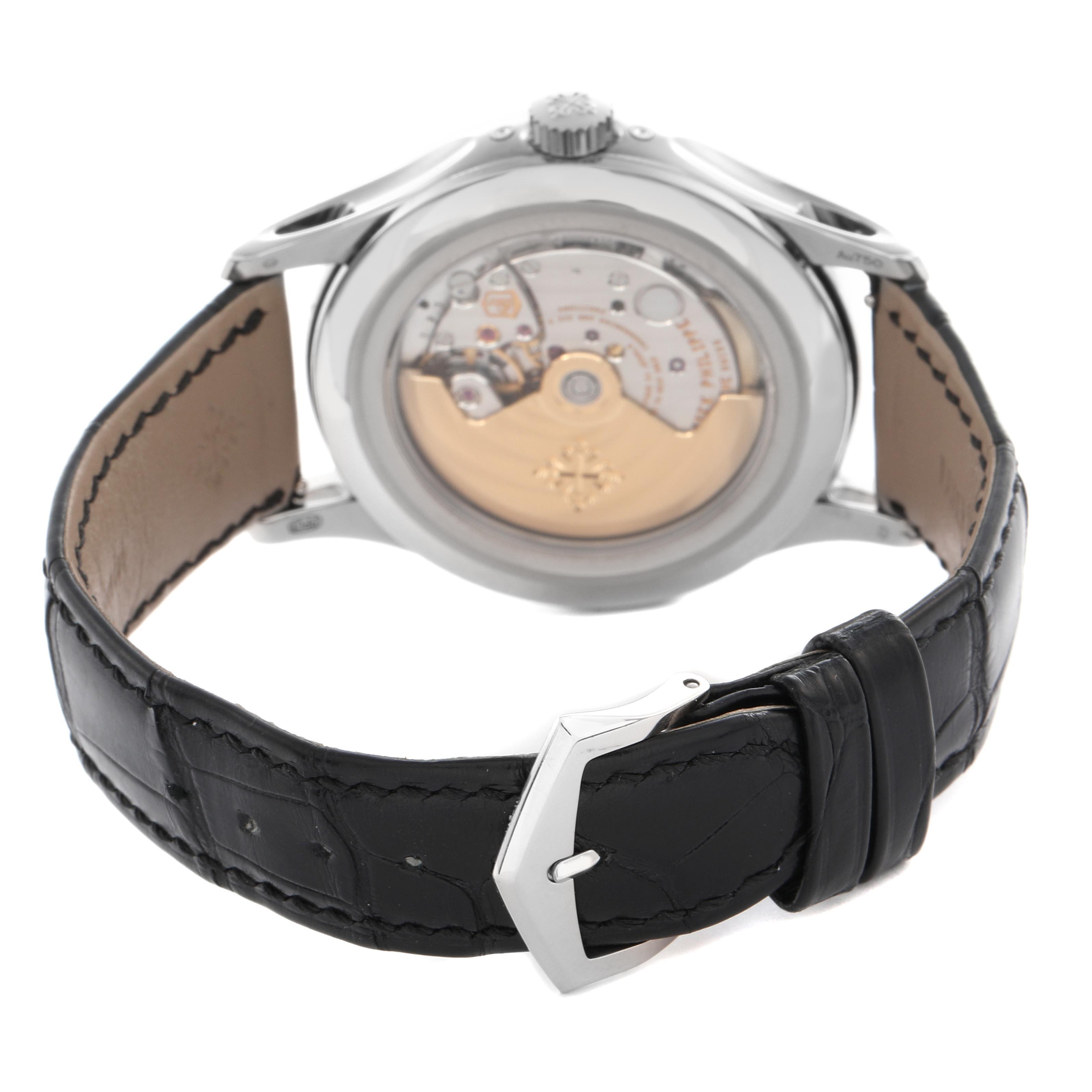 The image shows the back view of a Patek Philippe Complications 5205G-013 Men
s White Gold Blue Dial 5205G-013 Men
s White Gold Blue Dial watch, highlighting the movement and black leather strap.