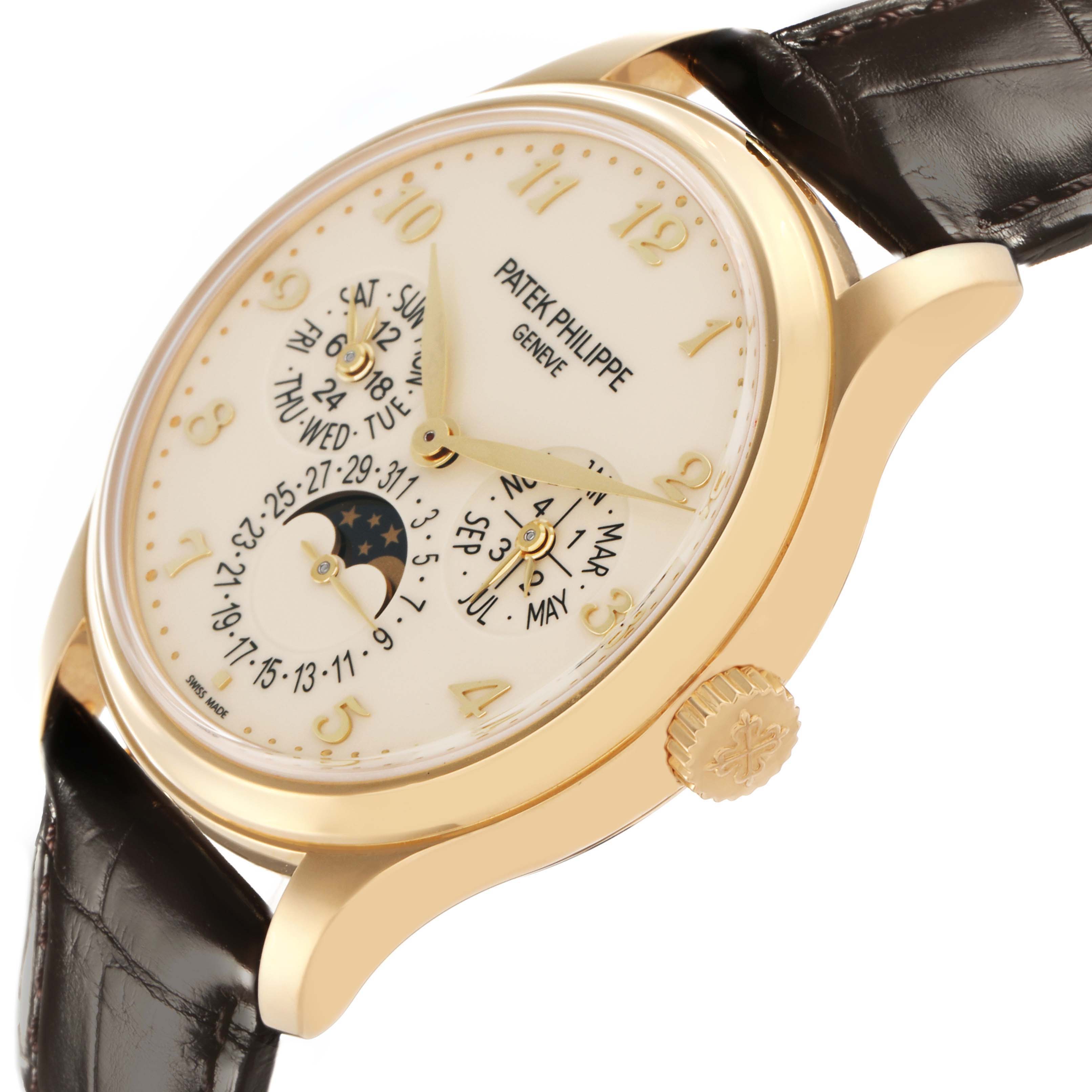 The image shows a Patek Philippe Complications 5327J Men
s Yellow Gold Beige Dial 5327J Men
s Yellow Gold Beige Dial watch at a slight angle, displaying the dial, crown, and part of the leather strap.