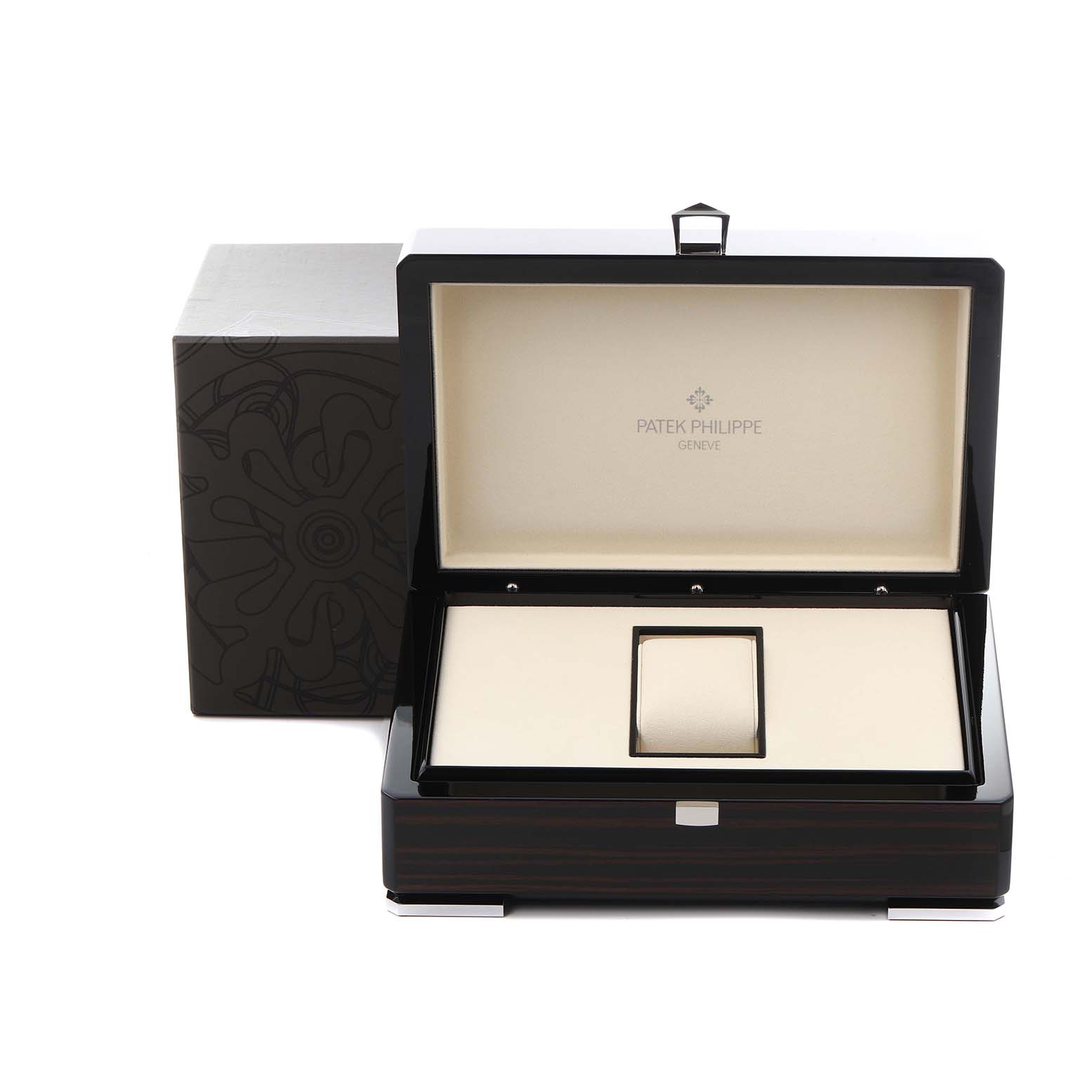 The image shows an open Patek Philippe Complications 5327J Men
s Yellow Gold Beige Dial 5327J Men
s Yellow Gold Beige Dial watch box, revealing its interior and cushion from a top angle.