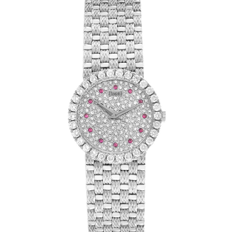 The Piaget Tradition 9190D23 watch is shown from the front, highlighting its diamond and ruby-encrusted face and bracelet.