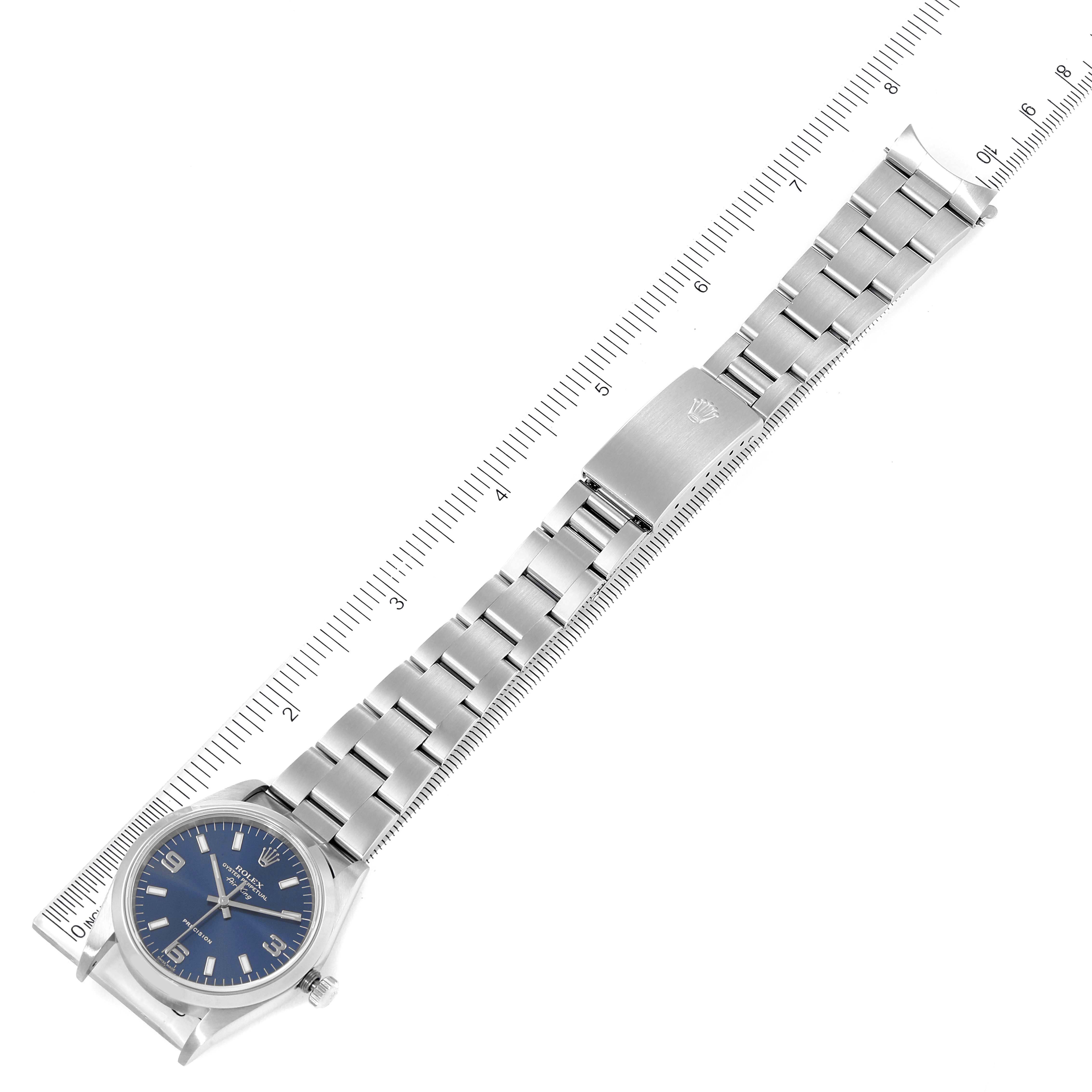 This image shows a top-down view of a Rolex Air-King 14000 Men's Stainless Steel Blue Dial 14000 Men's Stainless Steel Blue Dial watch and its metal bracelet, placed alongside a ruler for measurement.