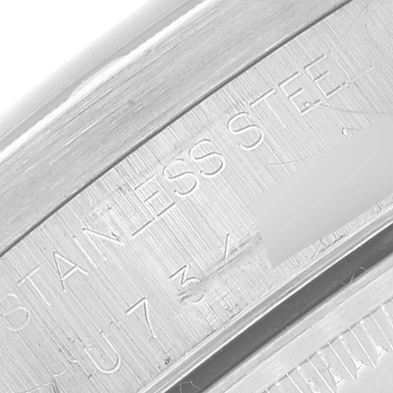 This close-up image shows the engraved details on the casing of a Rolex Air-King 14010 Men's Stainless Steel Blue Dial 14010 Men's Stainless Steel Blue Dial watch, indicating "STAINLESS STEEL."