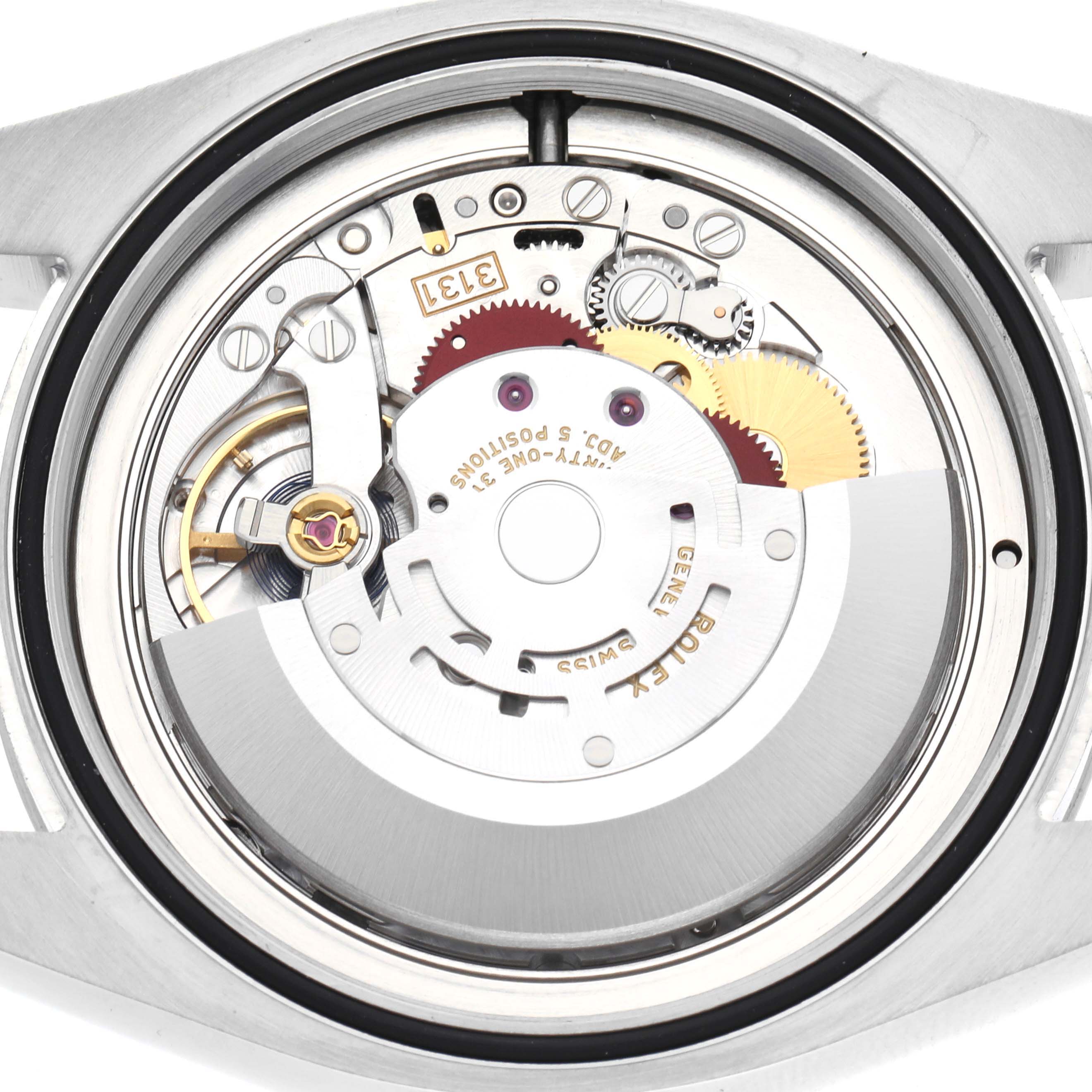 The image shows the movement of a Rolex Air-King 116900 Men
s Stainless Steel Black Dial 116900 Men
s Stainless Steel Black Dial watch, viewed from the back, highlighting gears and mechanical components.