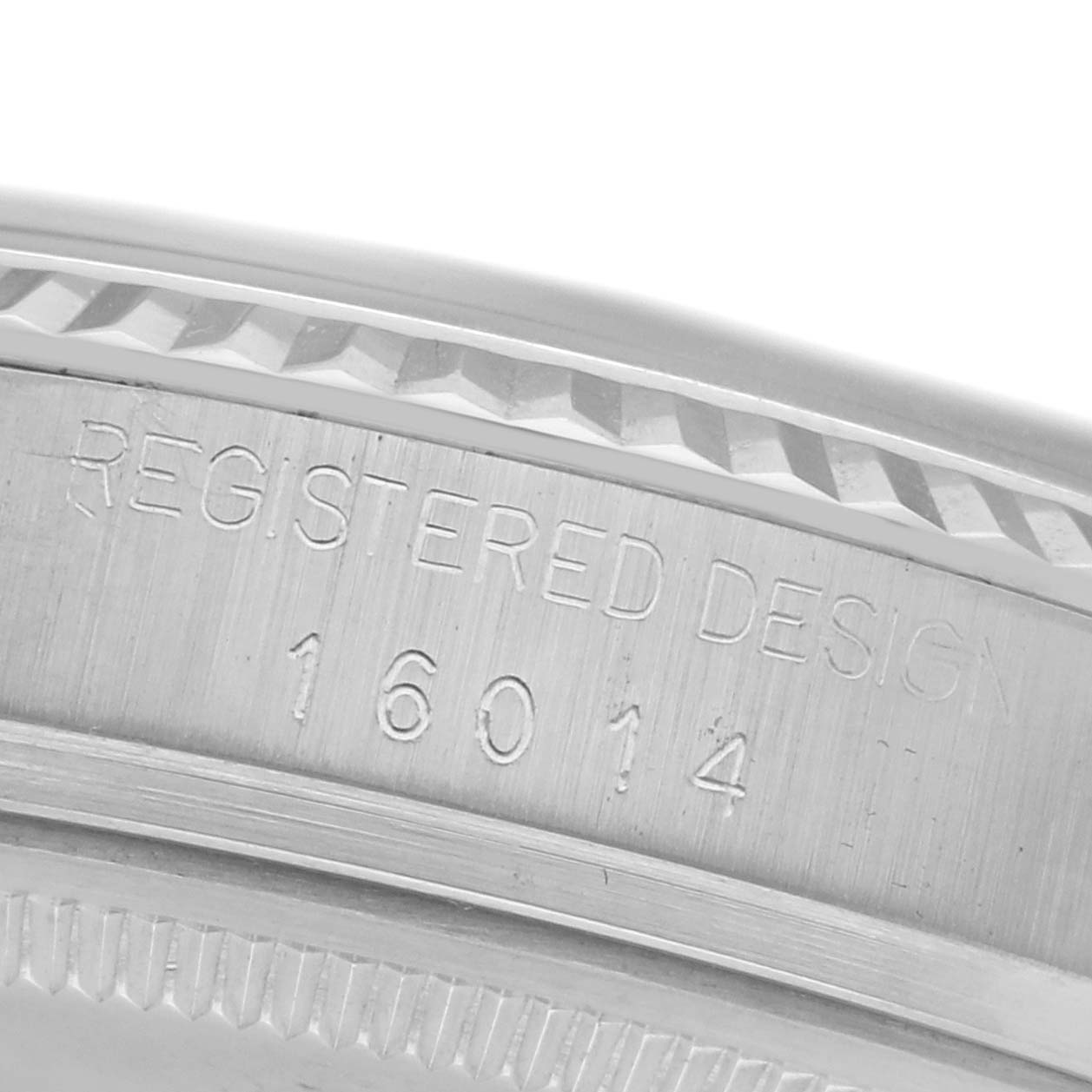 The image shows the side of a Rolex Datejust 68084 Men
s Stainless Steel Silver Dial 68084 Men
s Stainless Steel Silver Dial watch, highlighting the engraved design number and bezel.