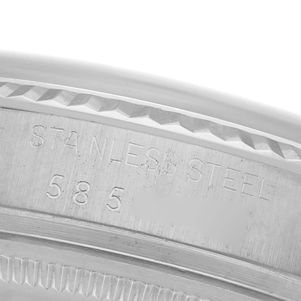 The image shows a close-up of the case back edge of a Rolex Datejust 68084 Men
s Stainless Steel Silver Dial 68084 Men
s Stainless Steel Silver Dial, highlighting the stainless steel material and reference number.