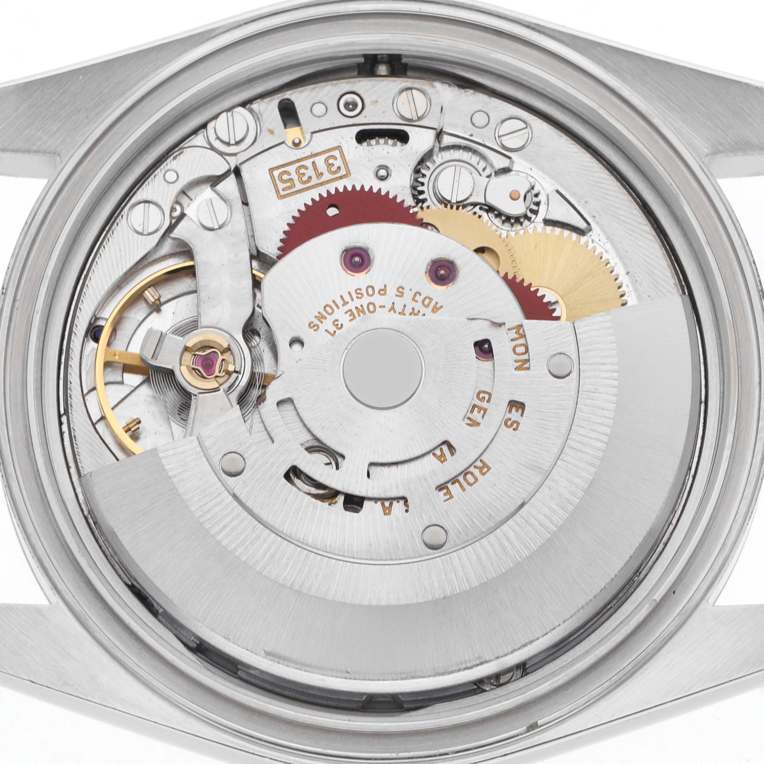 The image shows the Rolex Datejust 16234 Men
s Stainless Steel Silver Dial 16234 Men
s Stainless Steel Silver Dial watch movement with gears, rotor, and intricate components from a top-down angle.
