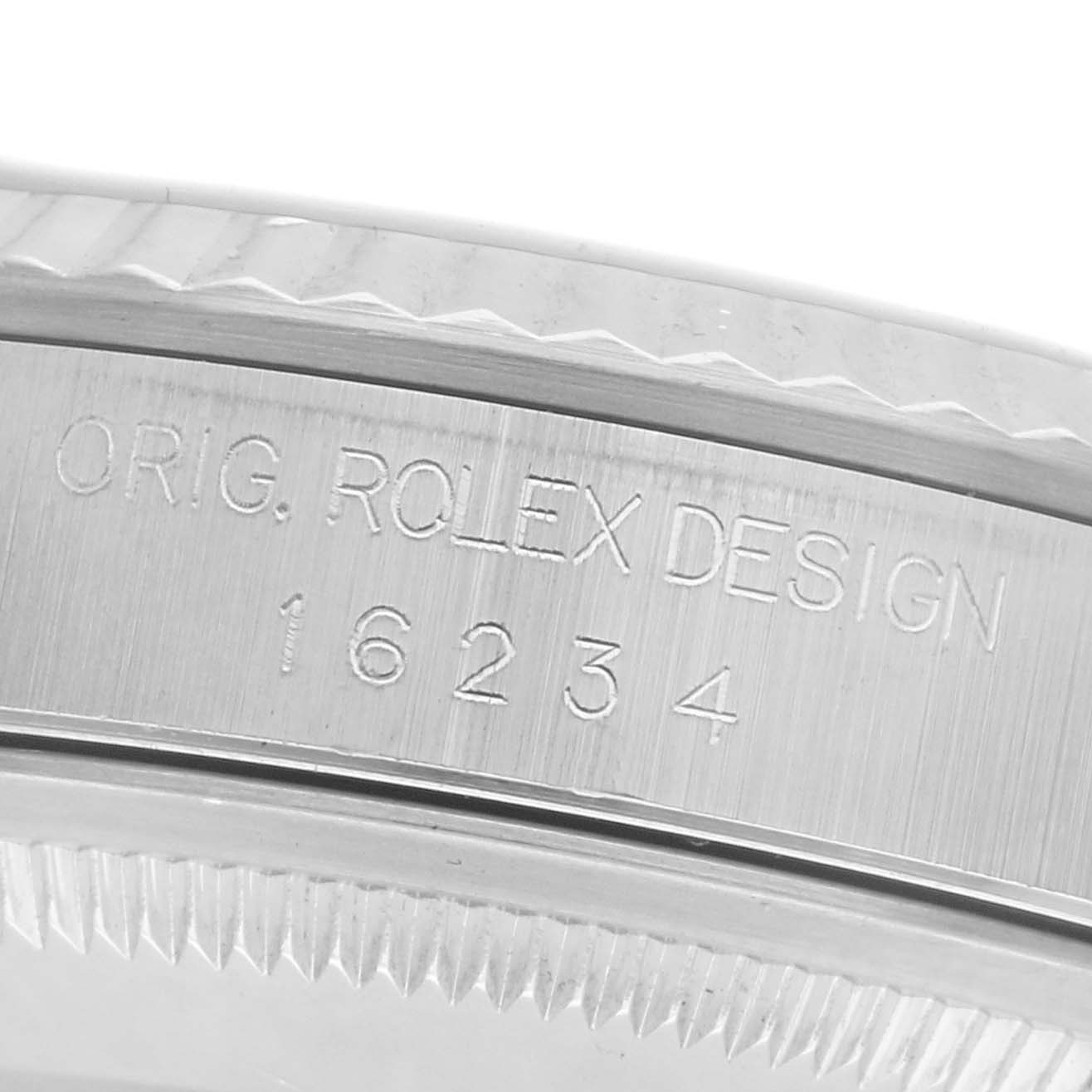The image shows a close-up of the side of a Rolex Datejust 16234 Men
s Stainless Steel Silver Dial 16234 Men
s Stainless Steel Silver Dial watch case, featuring its engraved design number.