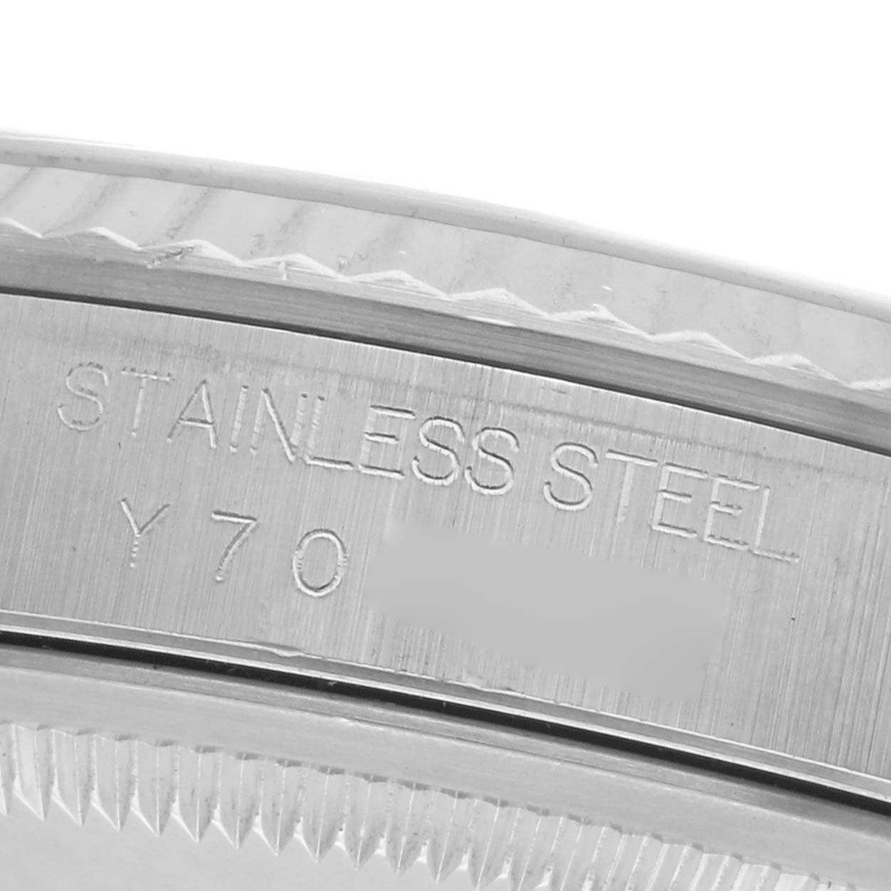 The image shows a close-up of the edge of a Rolex Datejust 16234 Men
s Stainless Steel Silver Dial 16234 Men
s Stainless Steel Silver Dial watch, highlighting the stainless steel engraving.