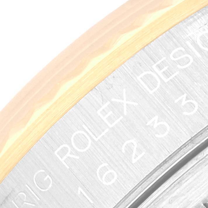 This image shows a close-up angle of the engraving on the bezel and case of a Rolex Datejust 16233 Men's Steel and Gold (two tone) Blue Dial 16233 Men's Steel and Gold (two tone) Blue Dial watch.