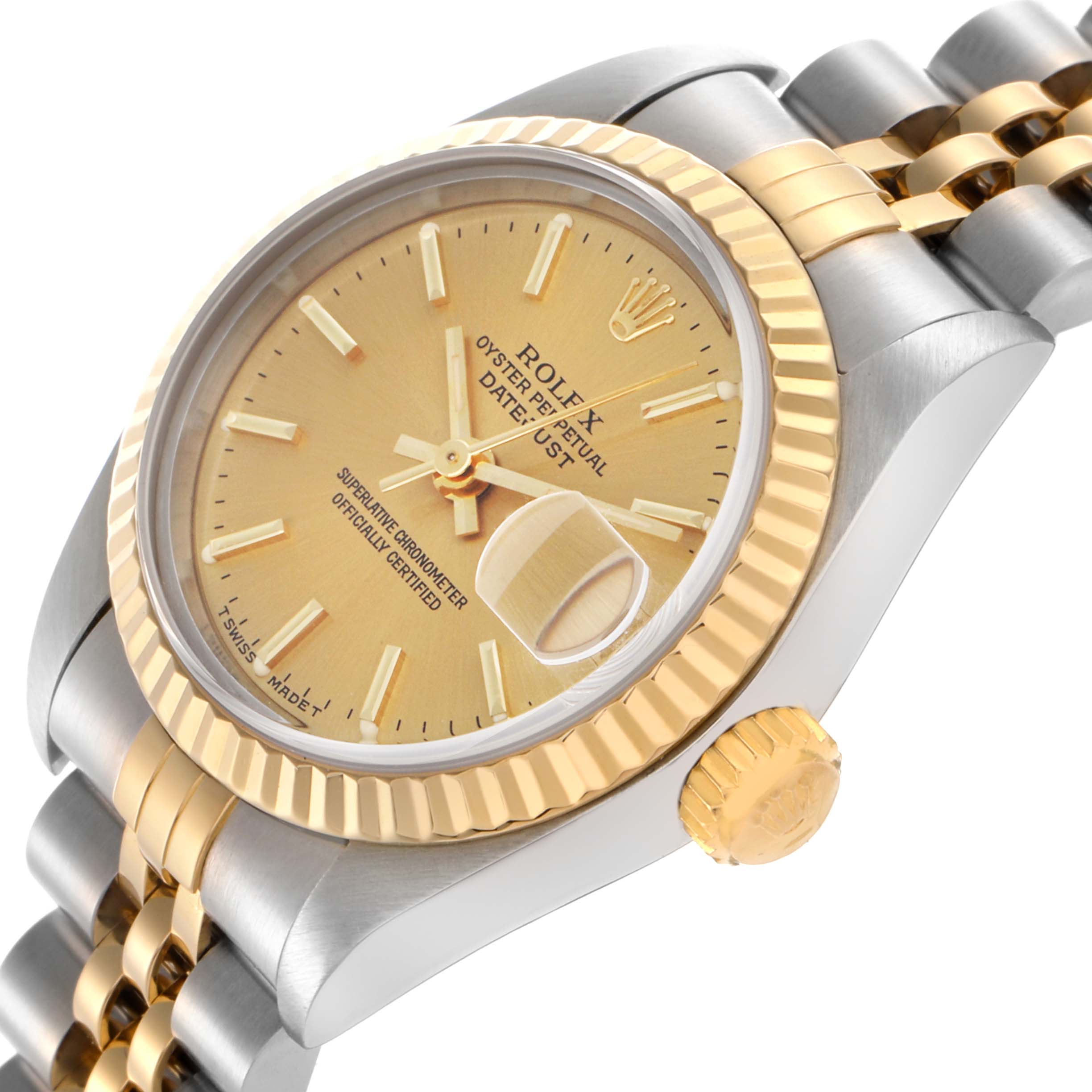 The Rolex Datejust 69173 Women
s Steel and Gold (two tone) Champagne Dial 69173 Women
s Steel and Gold (two tone) Champagne Dial watch is shown at an angle highlighting the gold bezel, dial, crown, and part of the two-tone bracelet.