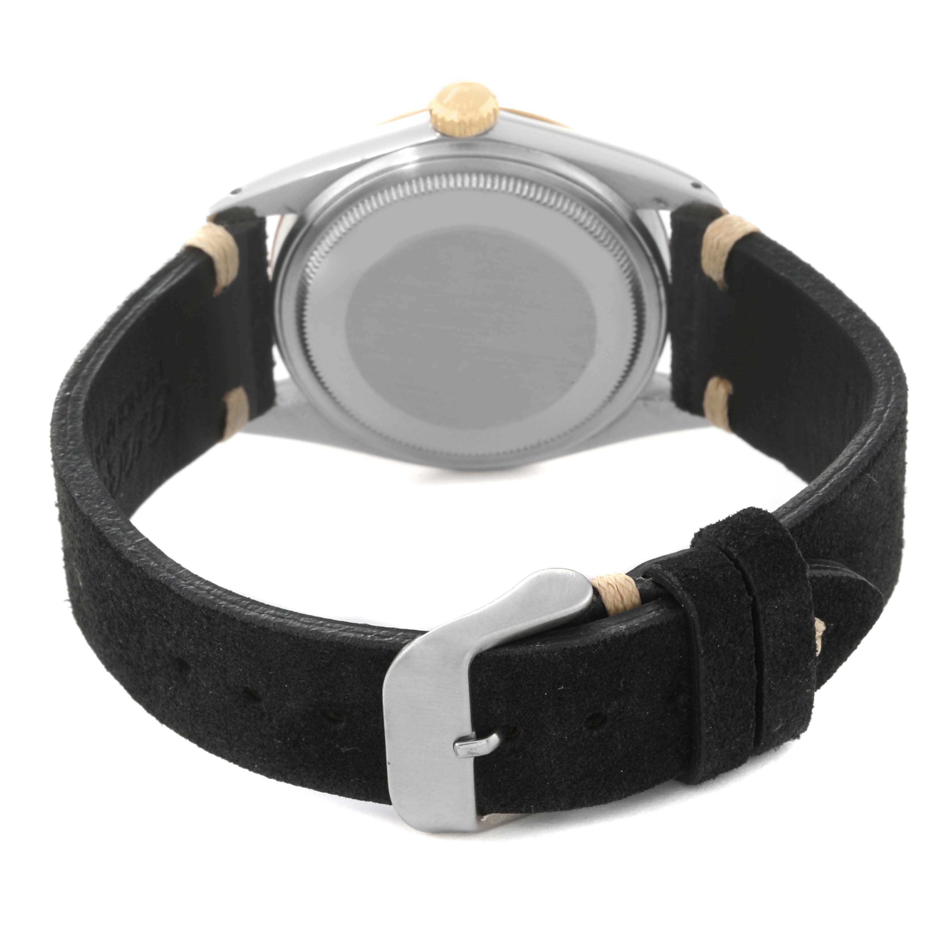 The image shows the back of a Rolex Vintage Collection 16013 Men's Steel and Gold (two tone) Champagne Dial 16013 Men's Steel and Gold (two tone) Champagne Dial watch and its black leather strap with a silver buckle.