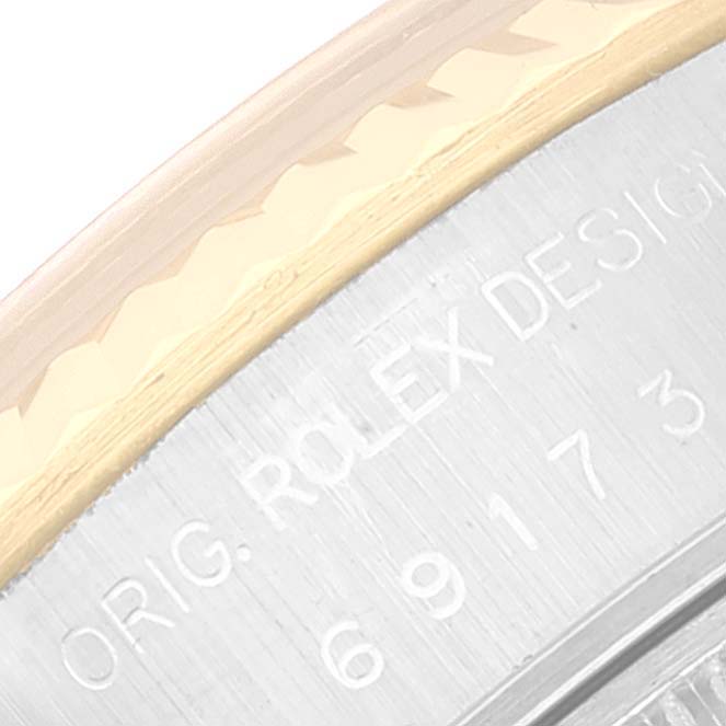 The image shows a close-up angle of the bezel and case back of a Rolex Datejust 69173 Women's Steel and Gold (two tone) Champagne Dial 69173 Women's Steel and Gold (two tone) Champagne Dial watch, highlighting the "ORIG. ROLEX DESIGN" engraving.