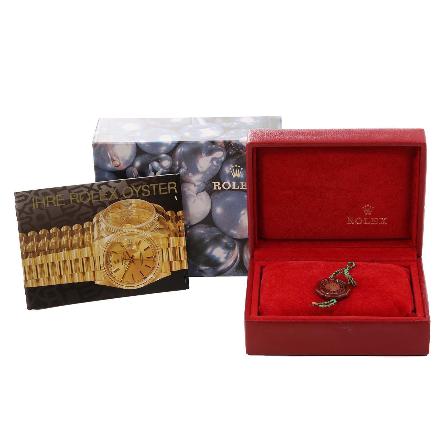 This image shows a red Rolex box, a booklet, and packaging for the Rolex Datejust 69173 Women's Steel and Gold (two tone) Champagne Dial 69173 Women's Steel and Gold (two tone) Champagne Dial model.