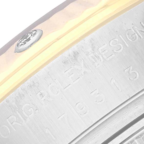 The image shows a close-up of the engraved text on the side of a Rolex Datejust 179313 Women's Steel and Gold (two tone) Mother of Pearl Dial 179313 Women's Steel and Gold (two tone) Mother of Pearl Dial watch case.