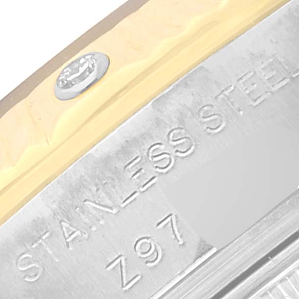 This close-up image focuses on the side of the Rolex Datejust 179313 Women's Steel and Gold (two tone) Mother of Pearl Dial 179313 Women's Steel and Gold (two tone) Mother of Pearl Dial watch, showcasing the "STAINLESS STEEL" engraving and a portion of the bezel.