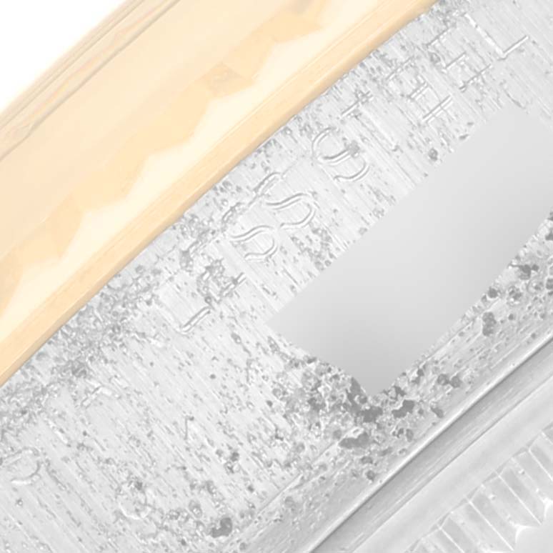 This close-up image shows the fine detailing and partial inscription on the bezel and case of a Rolex Vintage Collection 16013 Men's Steel and Gold (two tone) Champagne Dial 16013 Men's Steel and Gold (two tone) Champagne Dial watch.