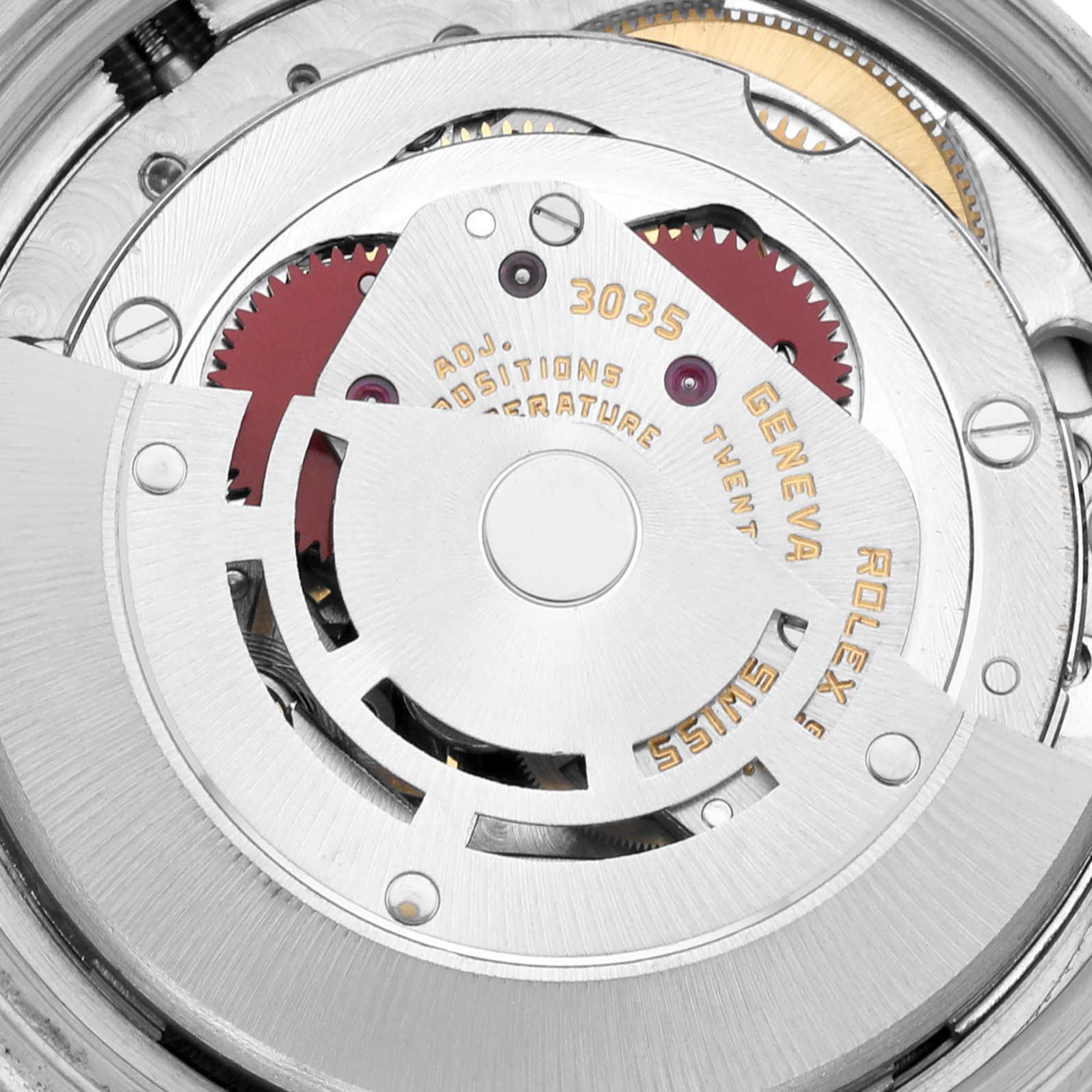 This image shows the intricate internal mechanism of the Vintage Collection Rolex model 3035, featuring gears and engraved text.